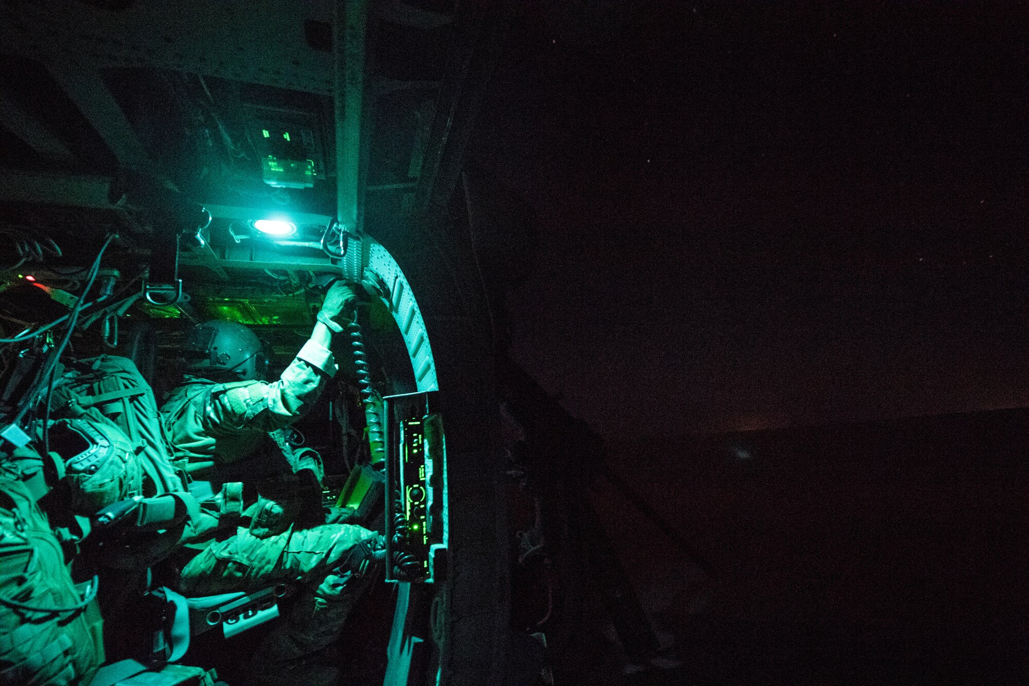 A U.S. Air Force special mission aviator assigned to the 46th Expeditionary Rescue Squadron sits onboard a HH-60G Pavehawk during a mission over Iraq, July 18, 2018. The primary mission of the HH-60G Pave Hawk helicopter is to conduct day or night personnel recovery operations into hostile environments to recover isolated personnel during war. (U.S. Air Force photo by Staff Sgt. Keith James)