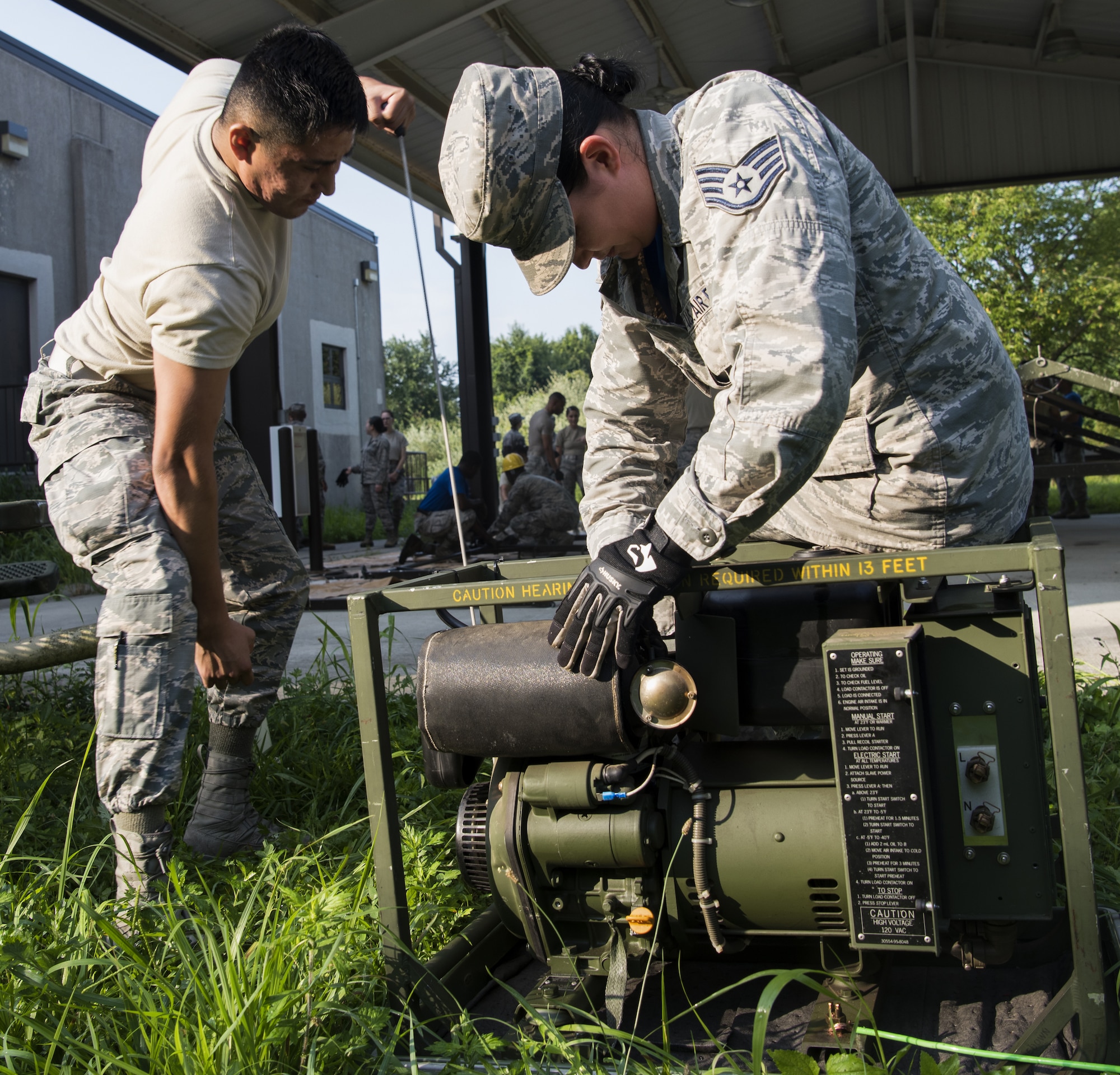 Airman Sebastian Lupe, 87th Force Support Squadron personalist, and U.S. Air Force Staff Sgt. Kendra Wysocki, 87th FSS installation dining facility contracting officer representative, attempt to start a two kilowatt generator during a Single Pallet Expeditionary Kitchen training exercise on Joint Base McGuire-Dix-Lakehurst, N.J., Aug. 17, 2018.  The generator supports the mobile kitchen which can be setup within two hours by eight people and is a requirement every 18 months for the services career field to perform.