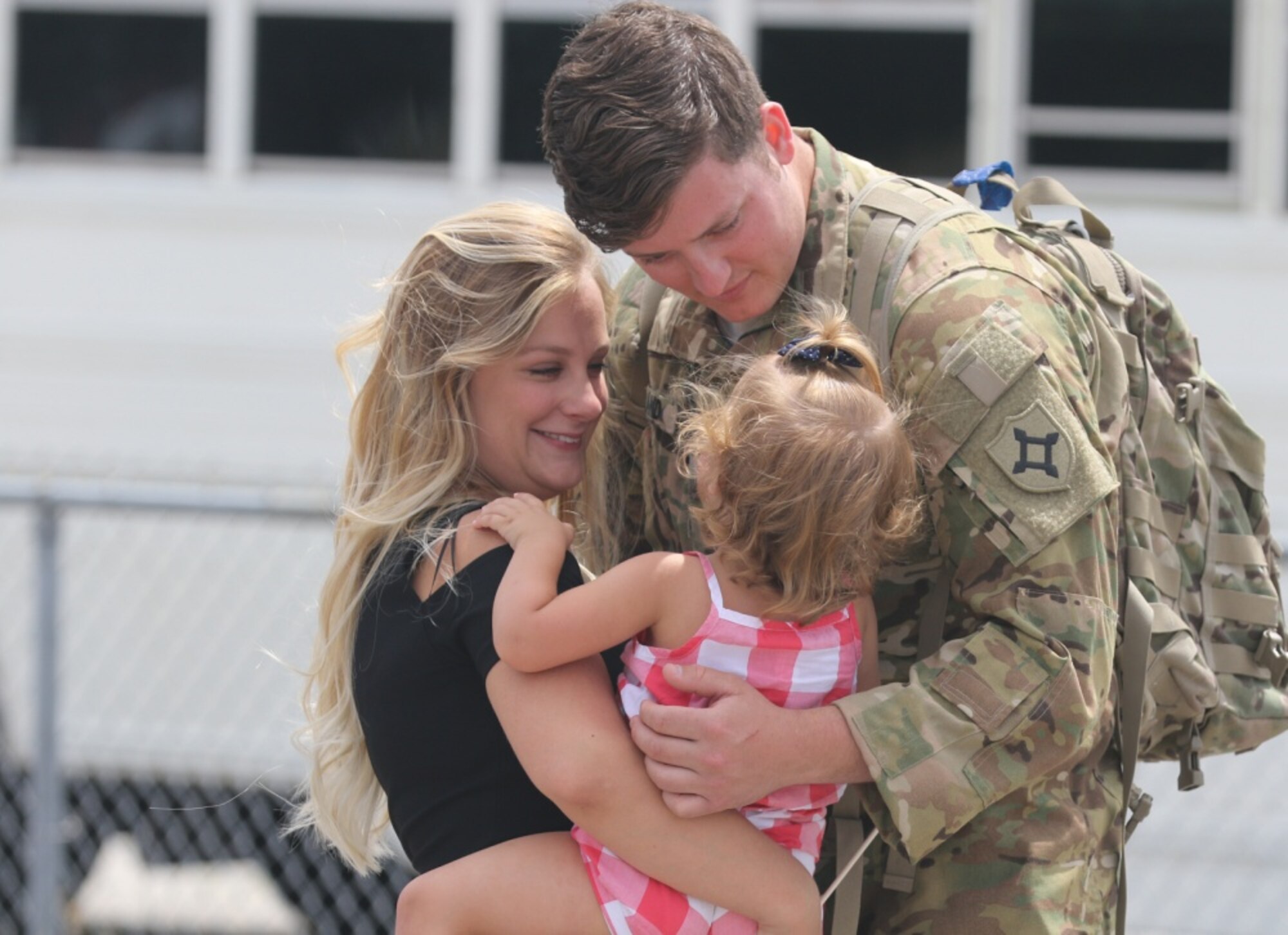 Spc. Alexander Rowland greets his wife and daughter at Jacksonville International Airport near Jacksonville, Florida, on April 29, 2017, after returning from a deployment. The DOD announced on Aug. 13, 2018 that eligibility for Military OneSource benefits for service members and their families has been extended from the current 180 days to 365 days after separation or retirement from military service.  (Photo Credit: U.S. Army photo by Staff Sgt. Shane Klestinski)
