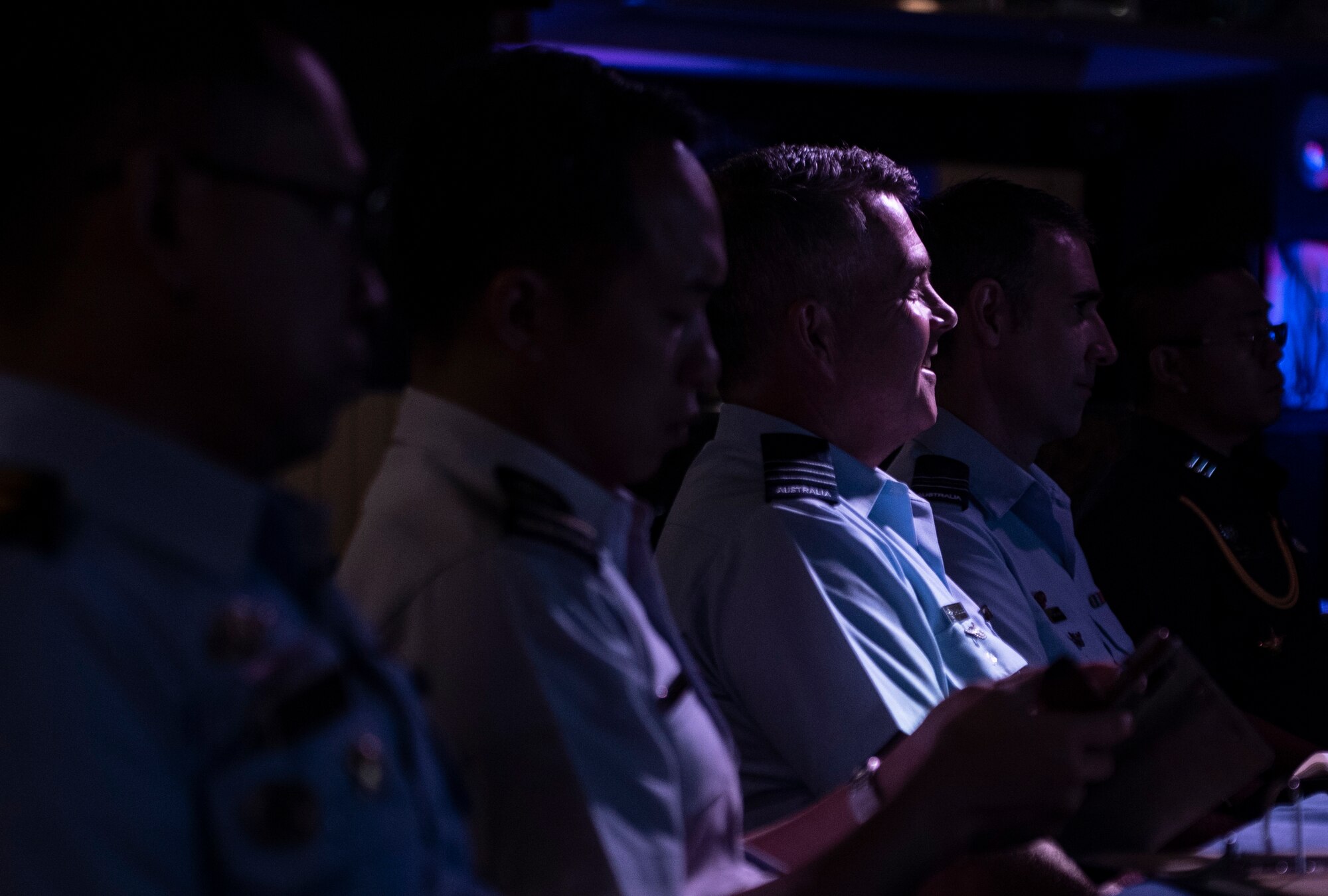 Officers of allied and partner nations listen to a briefing during the 2018 Fighter Logistics and Safety Symposium Aug. 21, 2018, at Kadena Air Base, Japan. Air force officers from Australia, Indonesia, Japan, the Philippines, Singapore and Thailand attended the symposium to boost fighter interoperability within the Pacific region. (U.S. Air Force photo by Staff Sgt. Micaiah Anthony)
