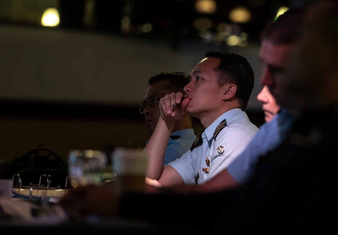 Officers of allied and partner nations listen to a briefing during the 2018 Fighter Logistics and Safety Symposium Aug. 21, 2018, at Kadena Air Base, Japan. Air force officers from Australia, Indonesia, Japan, the Philippines, Singapore and Thailand attended the symposium to boost fighter interoperability within the Pacific region. (U.S. Air Force photo by Staff Sgt. Micaiah Anthony)