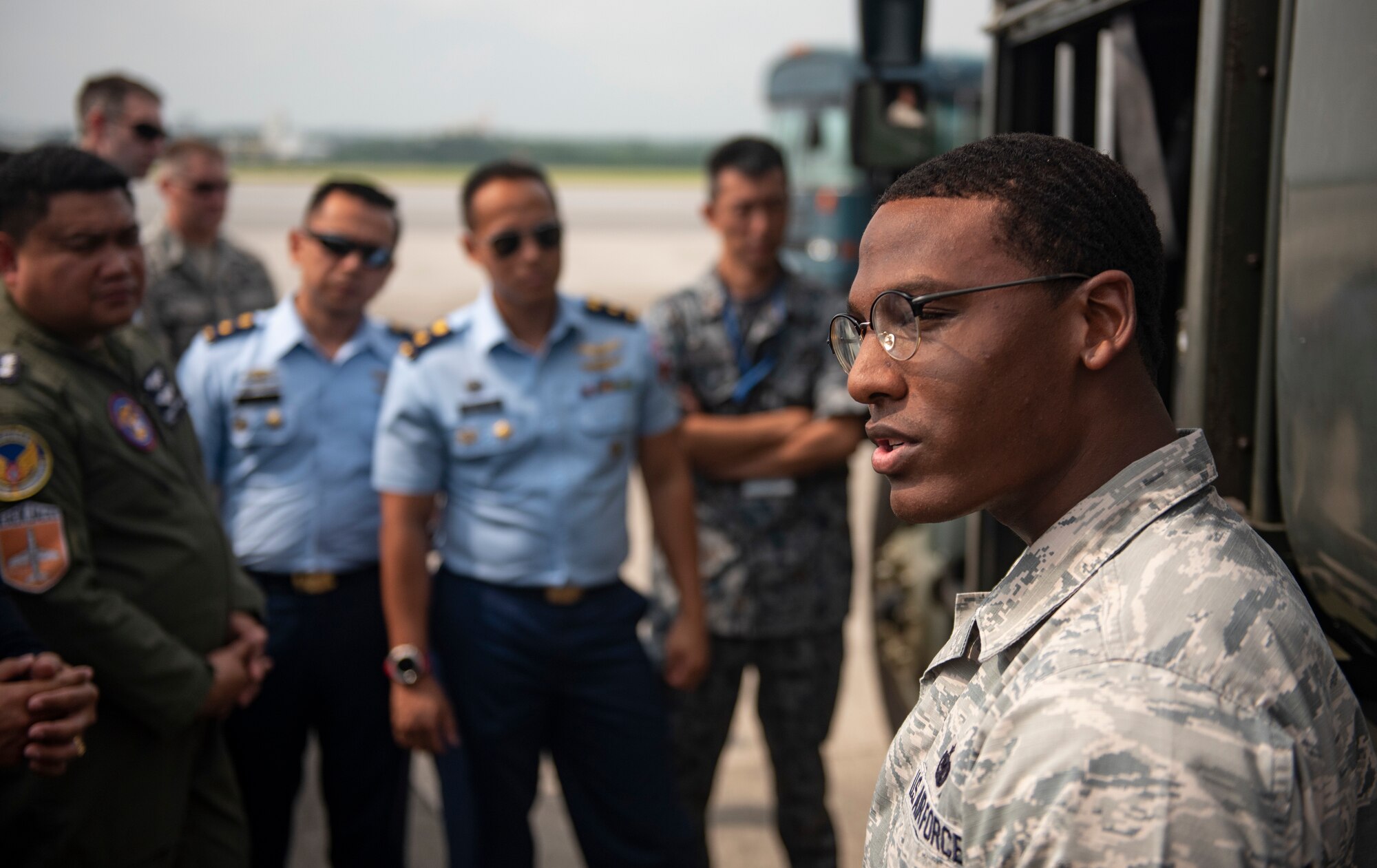 U.S. Air Force Staff Sgt. Jerald Hickmon, 18th Logistics Readiness Squadron Fuels Service Center NCOIC, briefs officers of allied and partner nations about aircraft fueling operations during the 2018 Fighter Logistics and Safety Symposium Aug. 21, 2018, at Kadena Air Base, Japan. The symposium enabled air force officers from Australia, Indonesia, Japan, the Philippines, Singapore and Thailand to visit fighter support units assigned to the 18th Wing and interact with Airmen who support the fighter mission. (U.S. Air Force photo by Staff Sgt. Micaiah Anthony)