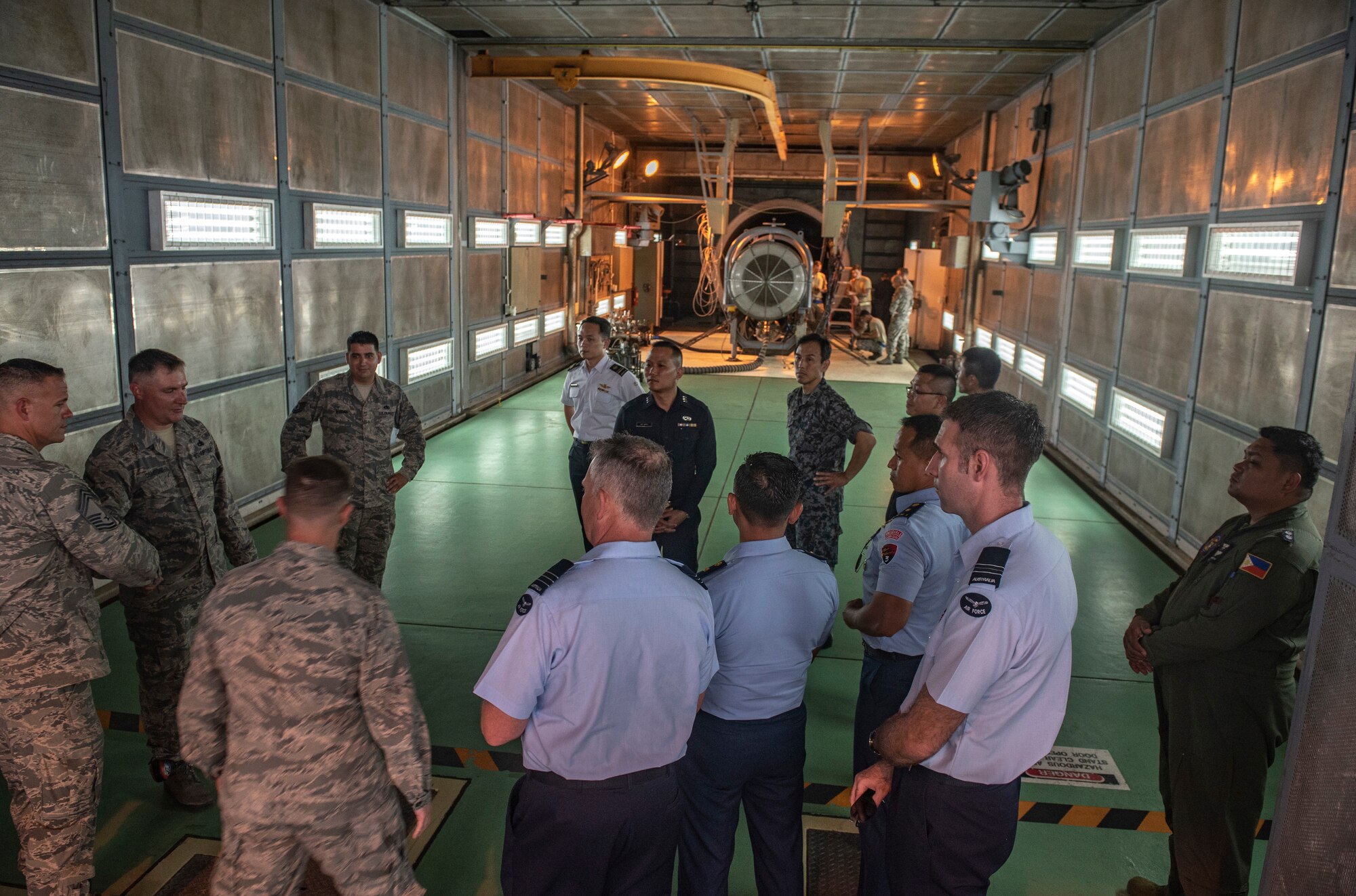 U.S. Air Force Tech Sgt. Travis Arrona, 18th Component Maintenance Squadron, briefs officers of allied and partner nations about aircraft engine maintenance and testing during the 2018 Fighter Logistics and Safety Symposium Aug. 21, 2018, at Kadena Air Base, Japan. The symposium enabled air force officers from Australia, Indonesia, Japan, the Philippines, Singapore and Thailand to visit fighter support units assigned to the 18th Wing and interact with Airmen who support the fighter mission. (U.S. Air Force photo by Staff Sgt. Micaiah Anthony)