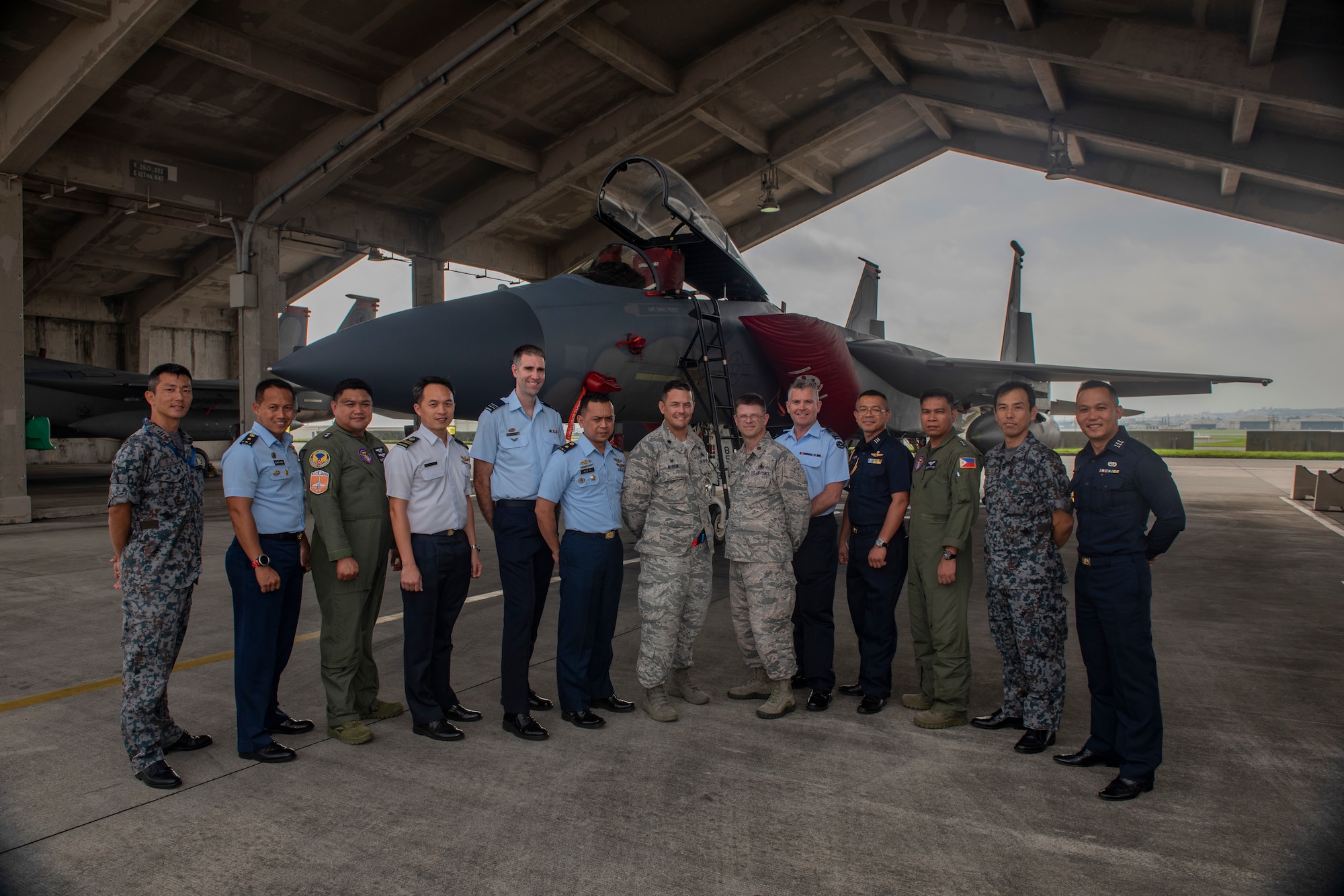 Officers from allied and partner nations pose for a group photo during the 2018 Fighter Logistics and Safety Symposium Aug. 21, 2018, at Kadena Air Base, Japan. During the symposium, air force officers from Australia, Indonesia, Japan, the Philippines, Singapore, Thailand and the U.S. exchanged solutions to common challenges faced in the fighter community. (U.S. Air Force photo by Staff Sgt. Micaiah Anthony)