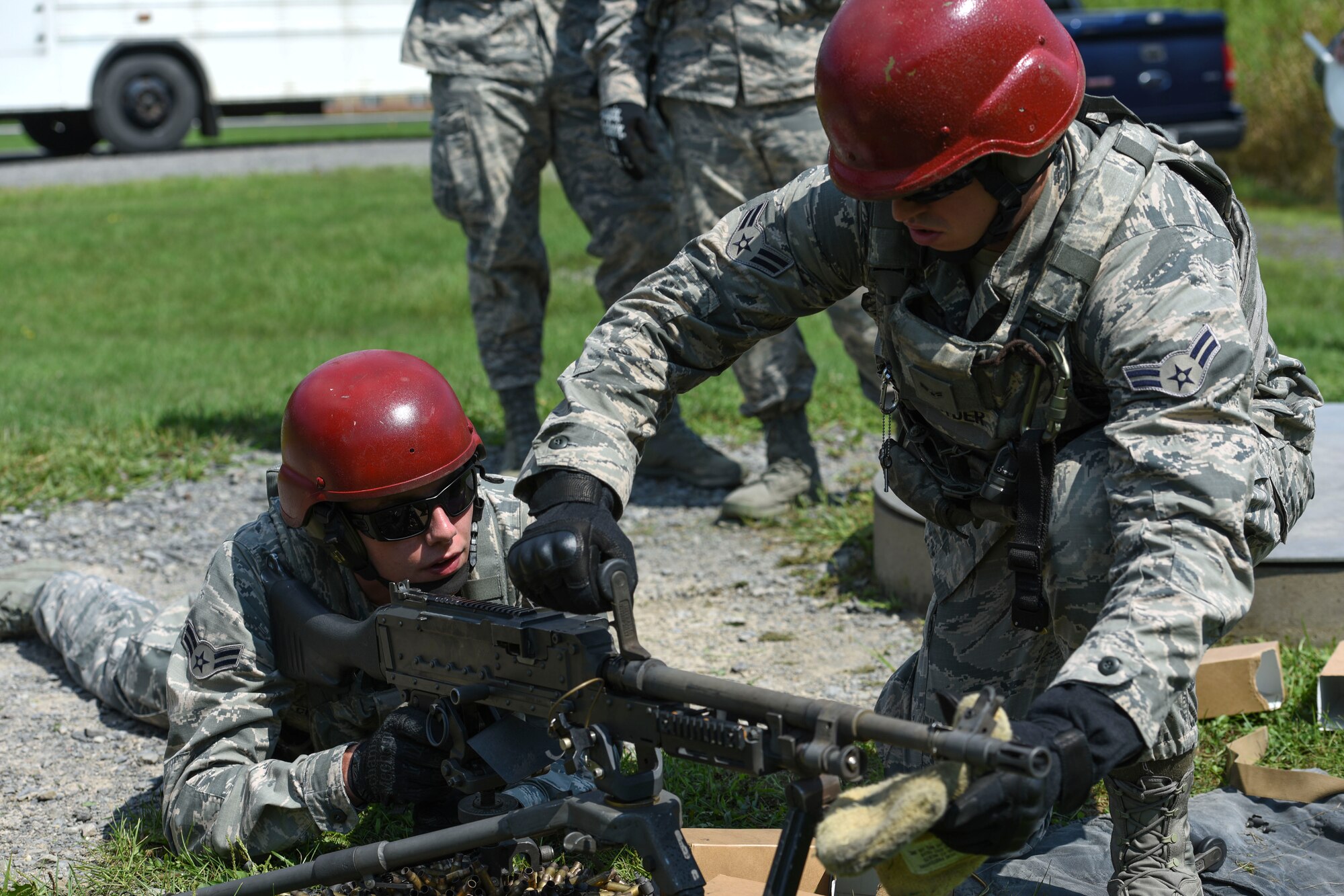 U.S. Air Force Airman 1st Class Joshua Snyder, Security Forces Specialist, changes the barrel on a 240B machine gun for A1C Theodore Cecotti, Security Forces Specialist, during a weapons qualification at Camp Dawson, W. Va., Aug. 6, 2018. Guardsmen from the 171SFS, located at the 171st Air Refueling Wing near Pittsburgh, traveled to Camp Dawson, August 5-8, 2018, to familiarize and qualify on the 240B and 249 machine guns. (U.S. Air National Guard photo by Tech. Sgt. Allyson L. Manners)