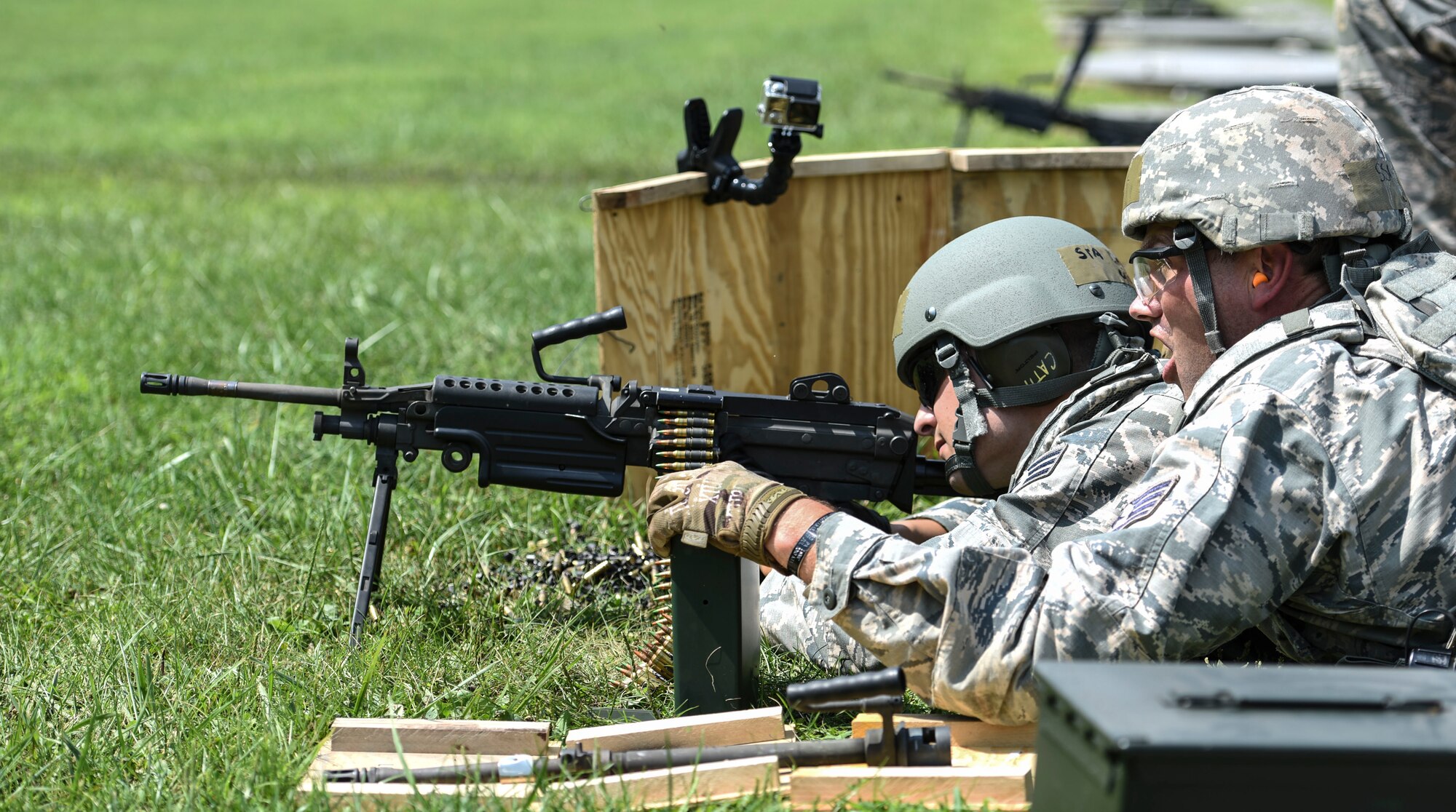 U.S. Air Force Staff Sgt. Cory Walker, Security Forces Specialist with the 171st Security Forces Squadron, located at the 171st Air Refueling Wing near Pittsburgh, assists U.S. Air Force Senior Airman Nicholas D’Arrigo during a weapons qualification at Camp Dawson, W. Va., Aug. 6, 2018. Guardsmen from the 171SFS traveled to Camp Dawson, August 5-8, 2018, to familiarize and qualify on the 240B and 249 machine guns. (U.S. Air National Guard photo by Tech. Sgt. Allyson L. Manners)