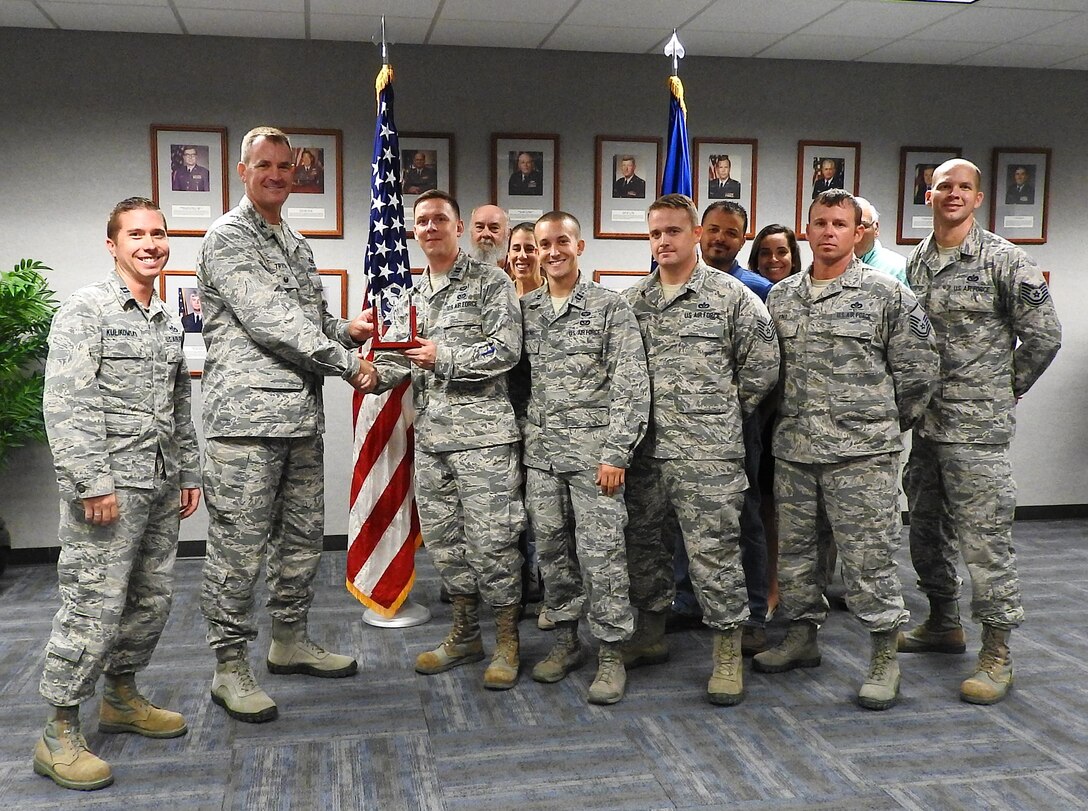 Here Colonel John Tryon AFCEC Operations Director, presents the APE Team the Joe Sciabica Teamwork Award for April to June 2018. It was also announced that the APE Team has received the General Mark Welsch III One Air Force Award for the entire Air Force.