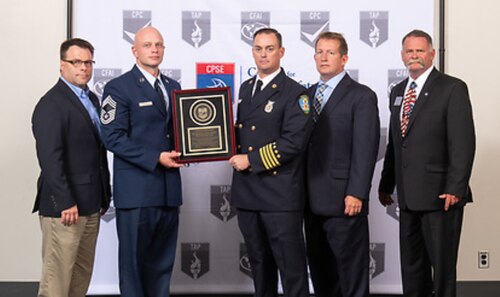 Fire and Emergency Services leadership pause for a photo with members of the Commission on Fire Accreditation International in honor of the MacDill Air Force Base, Fla., being awarded international reaccreditation status. The MacDill Fire and Emergency Services is currently one of only 24 Air Force agencies to receive this status.