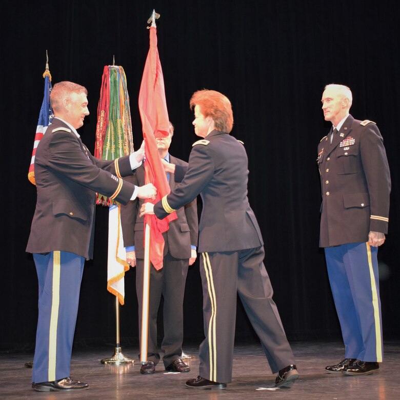 U.S. Army Corps of Engineers, South Atlantic Division Commander Brig. Gen. Diana Holland passes the colors to incoming Commander Col. Andrew Kelly during today's Change of Command ceremony. The ceremony symbolizes the passage of responsibility from departing commander to his successor.