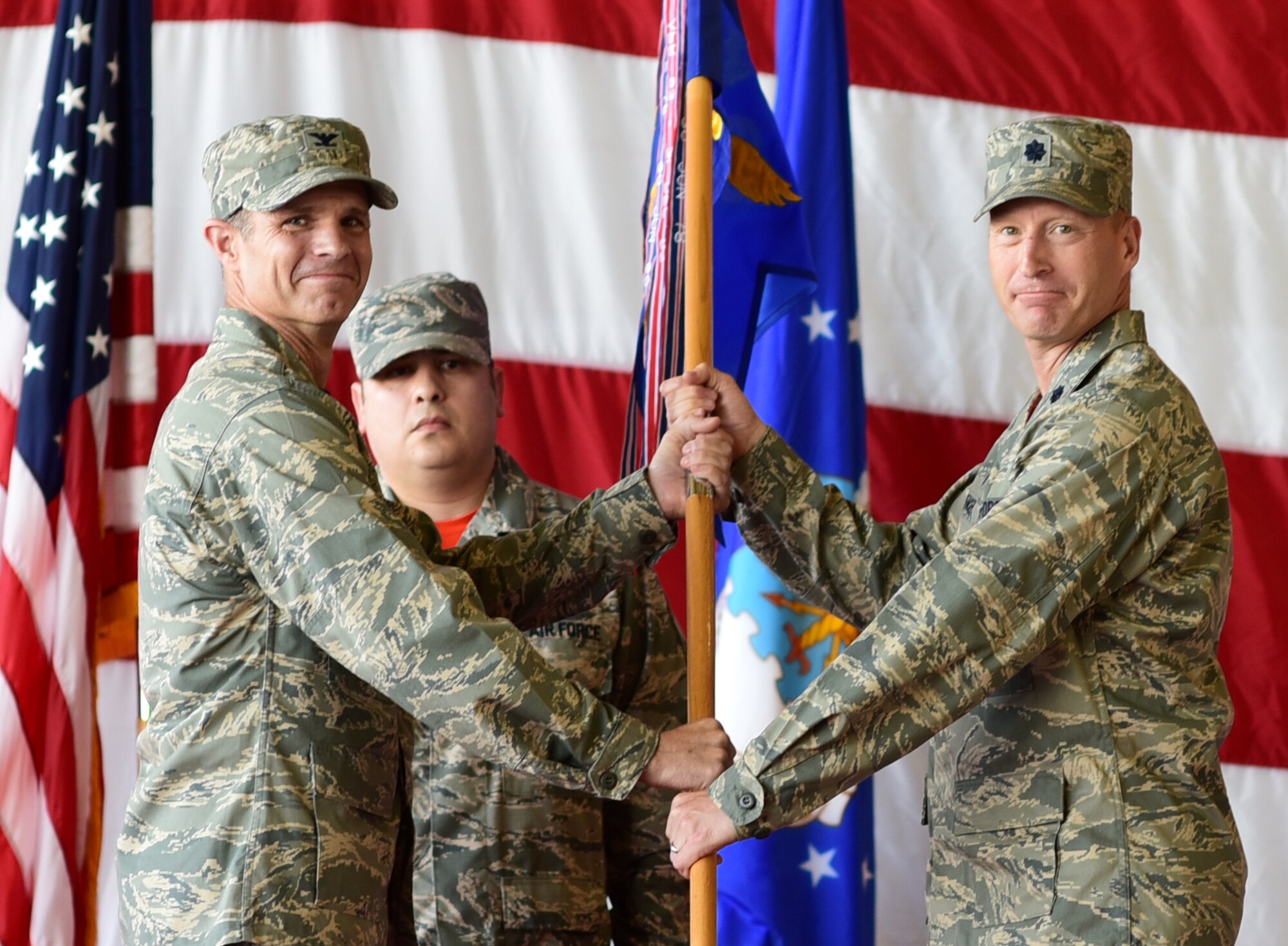 Col. Steven Boatright presents the ceremonial guidon to Lt. Col. Kendall Spencer.