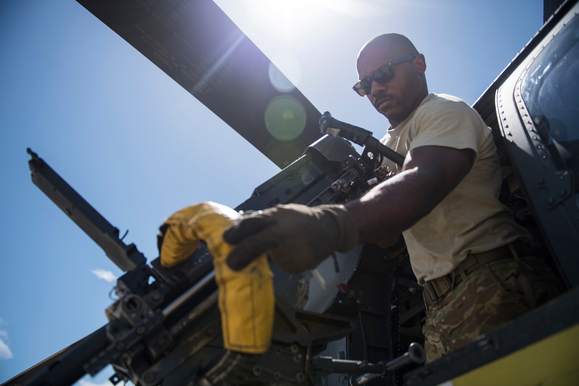 Tech. Sgt. Brandon Middleton, 41st Rescue Squadron (RQS) special missions aviator, inspects an M2 machine gun prior to a mission, Aug. 16, 2018, at Patrick Air Force Base (AFB), Fla. Airmen from the 41st RQS and 41st Helicopter Maintenance Unit traveled to Patrick AFB to participate in a spin-up exercise. During the exercise, Airmen faced scenarios and situations they may encounter downrange. (U.S. Air Force photo by Senior Airman Janiqua P. Robinson)