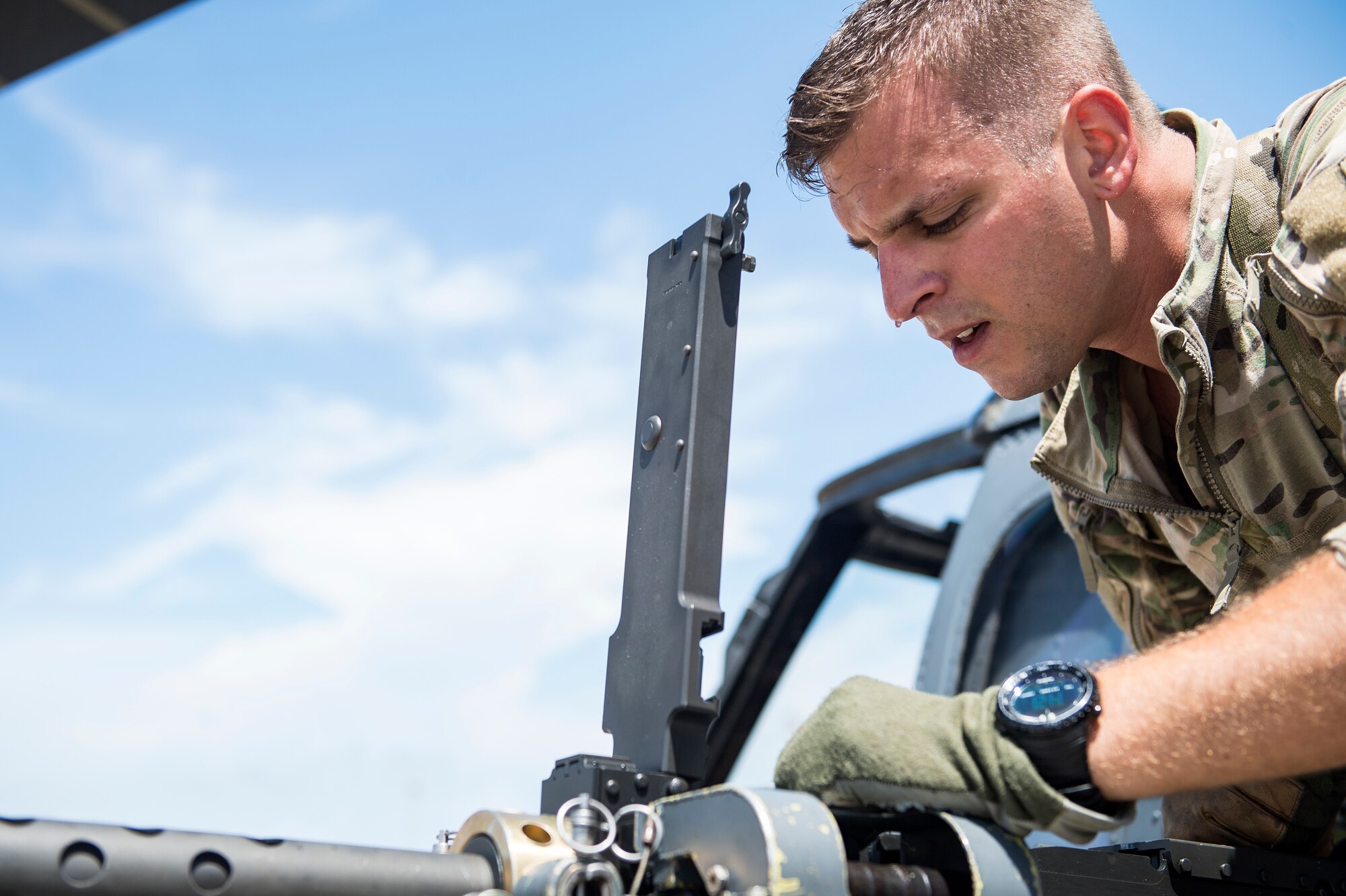 Staff Sgt. Daniel Paige, 41st Rescue Squadron (RQS) special missions aviator, inspects an M2 machine gun prior to a mission, Aug. 16, 2018, at Patrick Air Force Base (AFB), Fla. Airmen from the 41st RQS and 41st Helicopter Maintenance Unit traveled to Patrick AFB to participate in a spin-up exercise. During the exercise, Airmen faced scenarios and situations they may encounter downrange. (U.S. Air Force photo by Senior Airman Janiqua P. Robinson)