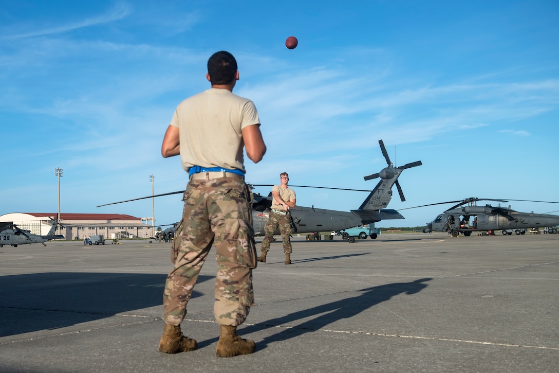 Airmen from the 41st Helicopter Maintenance Unit (HMU) play catch, Aug. 16, 2018, at Patrick Air Force Base, Fla. Airmen from the 41st Rescue Squadron and 41st HMU traveled to Patrick AFB to participate in a spin-up exercise. During the exercise, Airmen faced scenarios and situations they may encounter downrange. (U.S. Air Force photo by Senior Airman Janiqua P. Robinson)