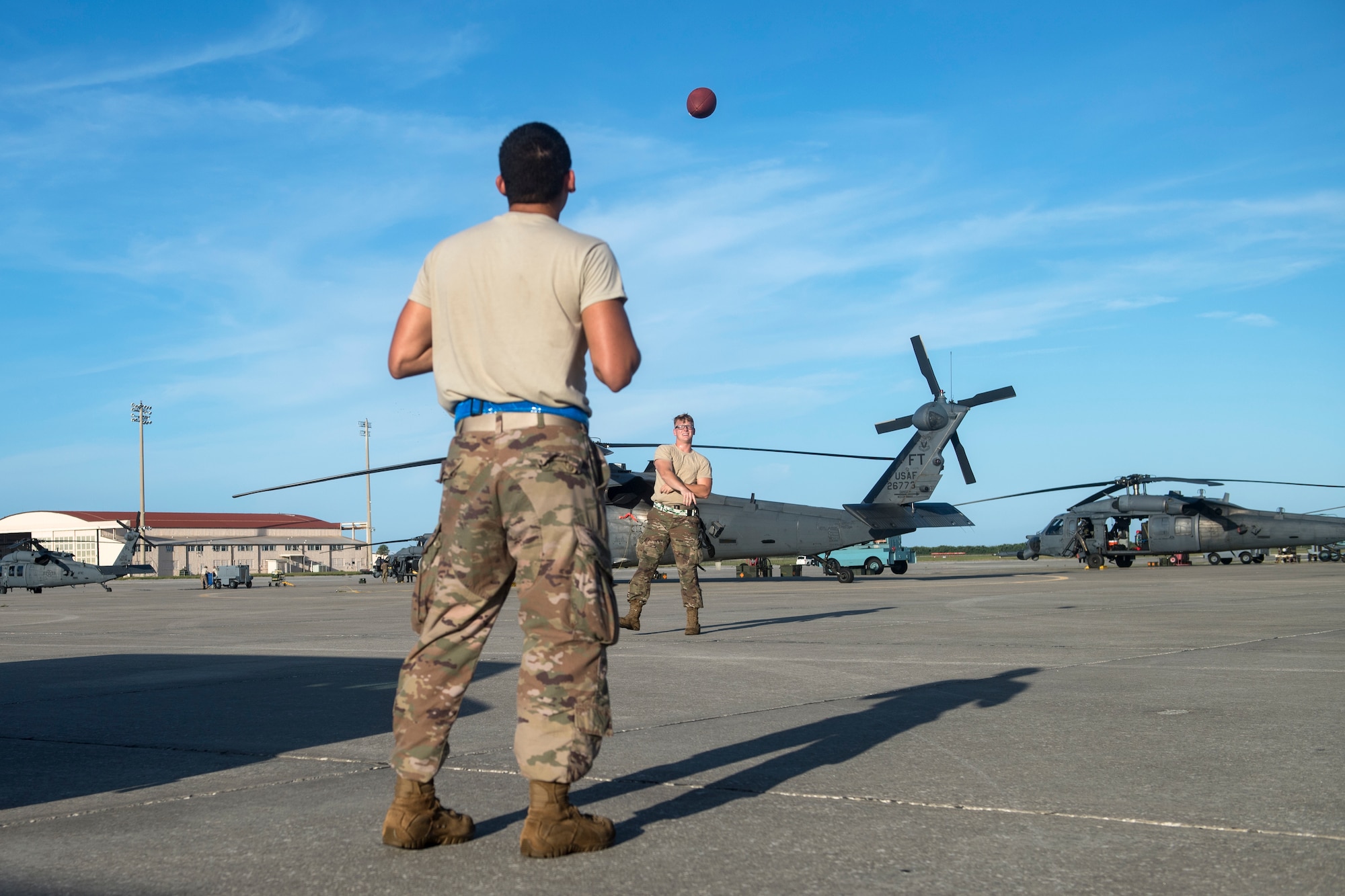 Airmen from the 41st Helicopter Maintenance Unit (HMU) play catch, Aug. 16, 2018, at Patrick Air Force Base, Fla. Airmen from the 41st Rescue Squadron and 41st HMU traveled to Patrick AFB to participate in a spin-up exercise. During the exercise, Airmen faced scenarios and situations they may encounter downrange. (U.S. Air Force photo by Senior Airman Janiqua P. Robinson)