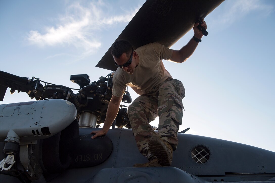 Staff Sgt. Jacob Schaake, 41st Helicopter Maintenance Unit (HMU) flying crew chief, performs an inspection on an HH-60G Pave Hawk, Aug. 16, 2018, at Patrick Air Force Base, Fla. Airmen from the 41st Rescue Squadron and 41st HMU traveled to Patrick AFB to participate in a spin-up exercise. During the exercise, Airmen faced scenarios and situations they may encounter downrange. (U.S. Air Force photo by Senior Airman Janiqua P. Robinson)