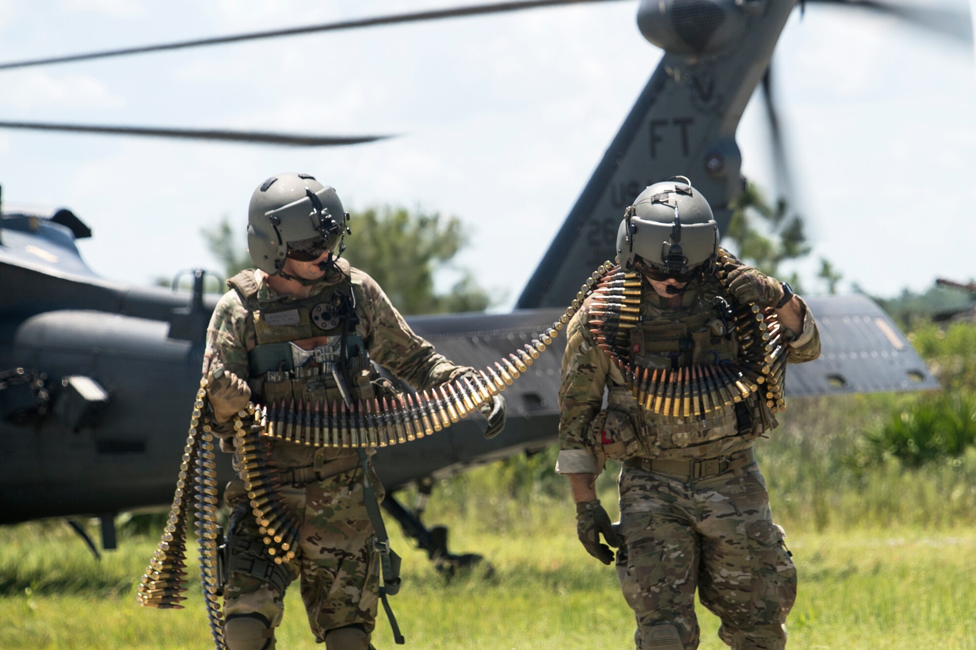 Special missions aviators from the 41st Rescue Squadron (RQS) carry ammunition to an HH-60G Pave Hawk, Aug. 17, 2018, at Patrick Air Force Base, Fla. Airmen from the 41st RQS and 41st Helicopter Maintenance Unit traveled to Patrick AFB to participate in a spin-up exercise. During the exercise, Airmen faced scenarios and situations they may encounter downrange. (U.S. Air Force photo by Senior Airman Janiqua P. Robinson)