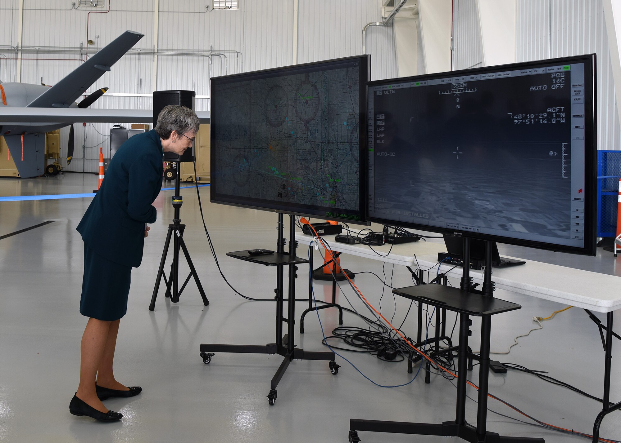 Secretary of the Air Force Heather Wilson looks at a display of movement of an unmanned aircraft system that took off from Grand Forks Air Force Base without the need for a chase plane to maintain visuals Aug 20, 2018. The new operation marked a milestone for the Grand Forks region, military, unmanned aircraft system business and national security. (U.S. Air Force photo by Senior Airman Cierra Presentado)