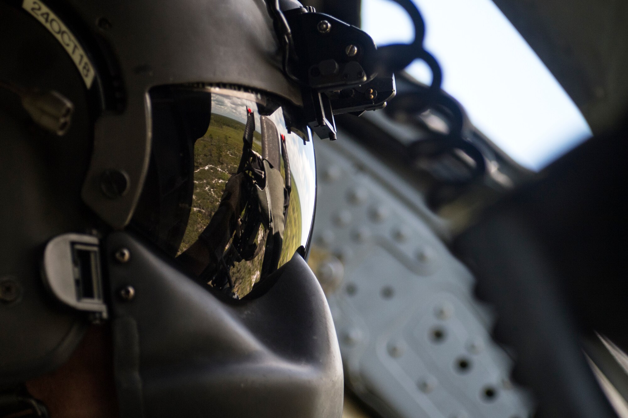 A special missions aviator from the 41st Rescue Squadron (RQS) aims the .50 caliber machine gun mounted to an HH-60G Pave Hawk, Aug. 17, 2018, at Patrick Air Force Base, Fla. Airmen from the 41st RQS and 41st Helicopter Maintenance Unit traveled to Patrick AFB to participate in a spin-up exercise. During the exercise, Airmen faced scenarios and situations they may encounter downrange. (U.S. Air Force photo by Senior Airman Janiqua P. Robinson)
