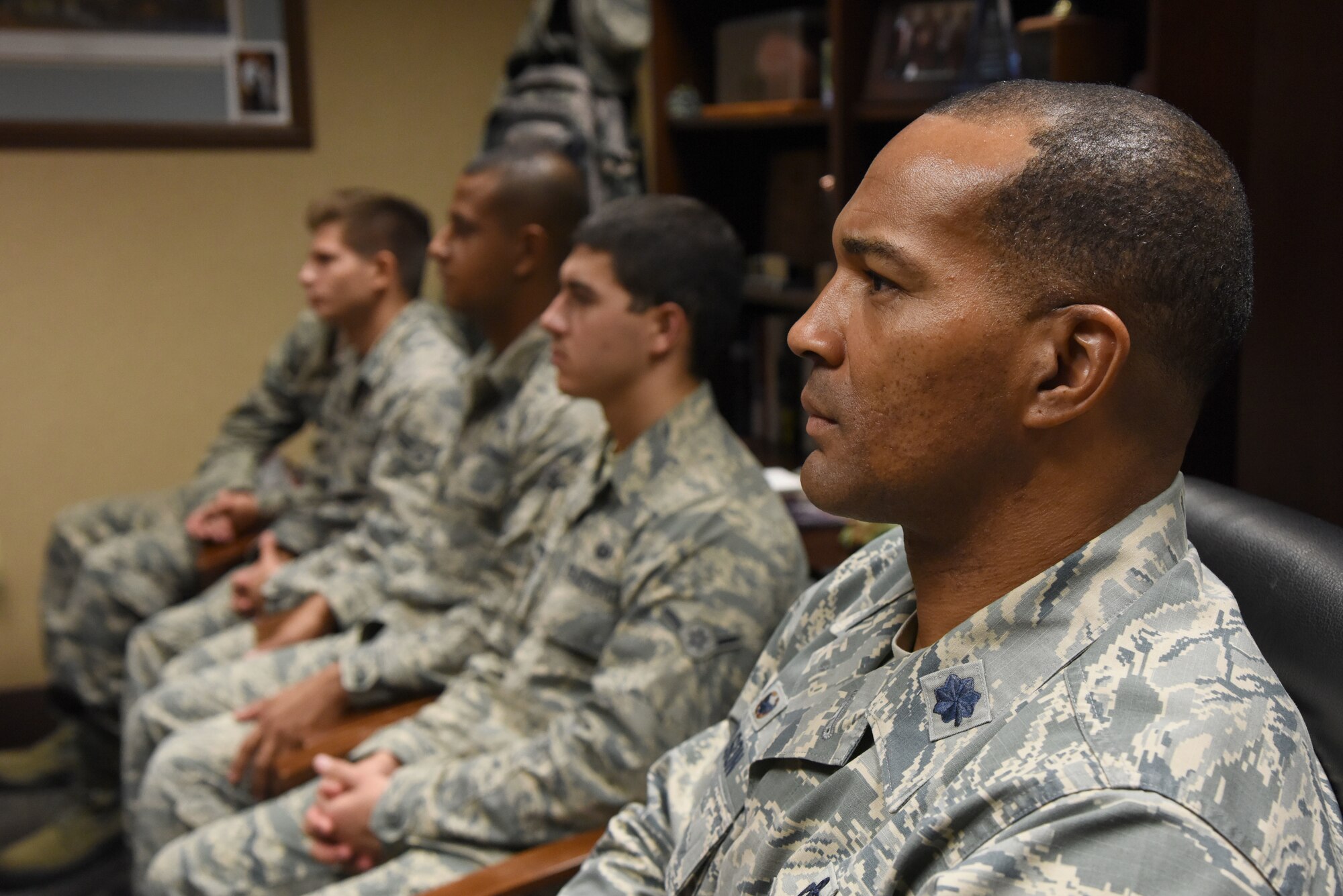 U.S. Air Force Lt. Col. Billy Wilson, 334th Training Squadron commander, sits with Airmen as they watch a televised Medal of Honor presentation at Cody Hall at Keesler Air Force Base, Mississippi, Aug. 23, 2018. Tech. Sgt. John Chapman was posthumously awarded the Medal of Honor, the nation�s highest award for valor in combat, by U.S. President Donald Trump. Chapman was killed in Afghanistan on March 4, 2002. He attended the air traffic control course at Keesler in 1989. (U.S. Air Force photo by Kemberly Groue)