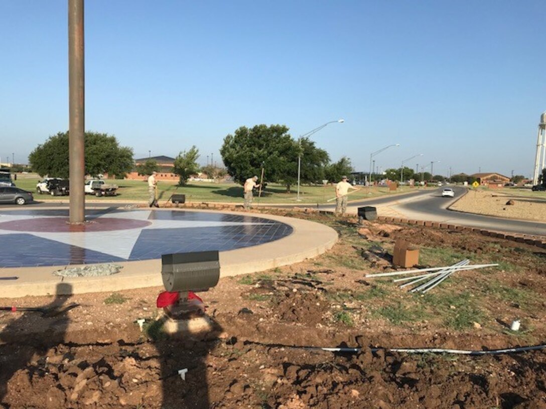 U.S. Air Force Airmen with the 7th Civil Engineer Squadron remove the mulch and dirt from the top tier of the traffic circle July 8, 2018 at Dyess Air Force Base, Texas.