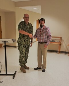 NSWC Crane Employee Toby Evans Recieves Medal of Valor, presented by CAPT Mark Oesterreich.