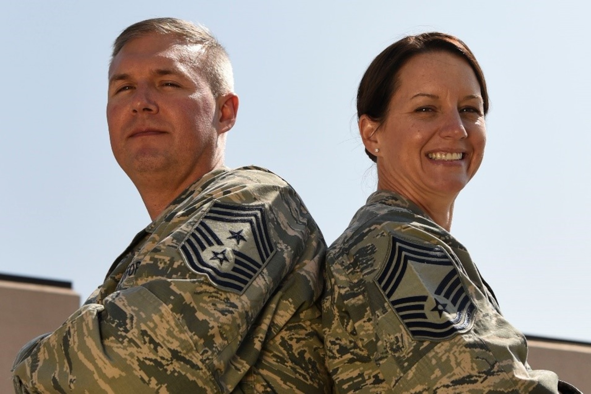 Chief Master Sgt. Brian Thomas, the 319th Air Base Wing command chief, and Chief Master Sgt. Shannon Thomas, the 69th Maintenance Squadron chief enlisted manager, stand outside for a photo on August 22, 2018, on Grand Forks Air Force Base, North Dakota. With more than 40 years of combined military service, B. Thomas and S. Thomas have experienced continuous growth in their career and family. (U.S. Air Force Photo by Airman 1st Class Melody Wolff)