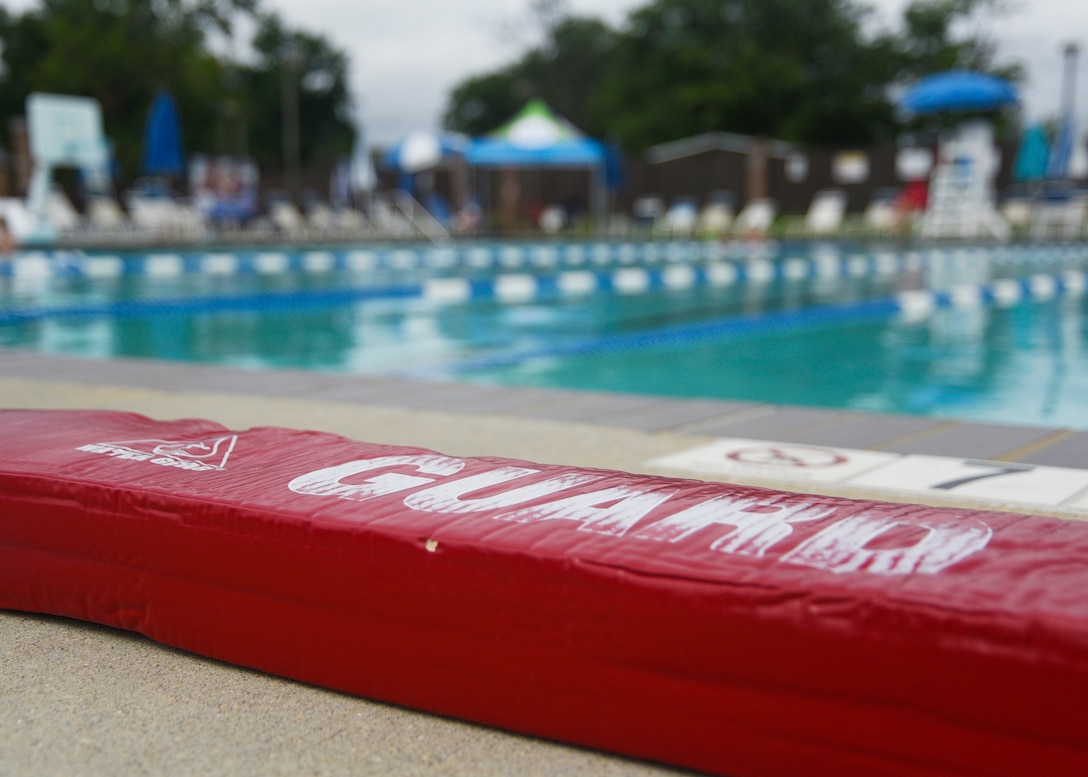 A lifeguard rescue tube is placed on the edge of the pool during the third annual water safety camp at Joint Base Andrews, Md., Aug. 21, 2018. During the camp, participants learned the basics of swimming and water safety. (U.S. Air Force photo by Senior Airman Abby L. Richardson)