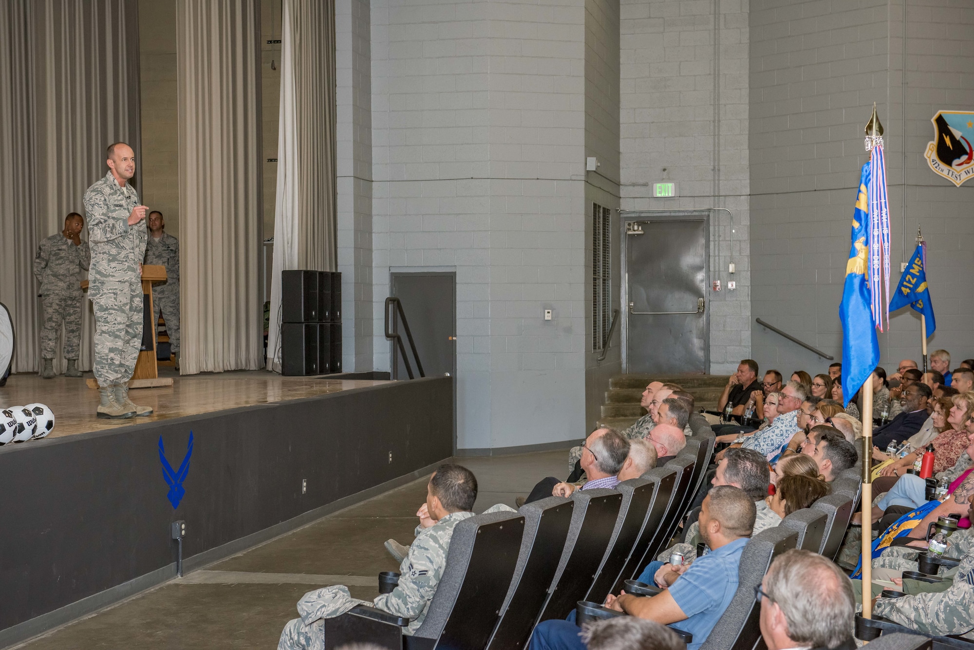 Brig. Gen. E. John Teichert, 412th Test Wing commander, addresses a full base theater Aug. 23 at his first commander's call. Teichert took command of the 412th Test Wing last month." (U.S. Air Force photo by Matt Williams)
