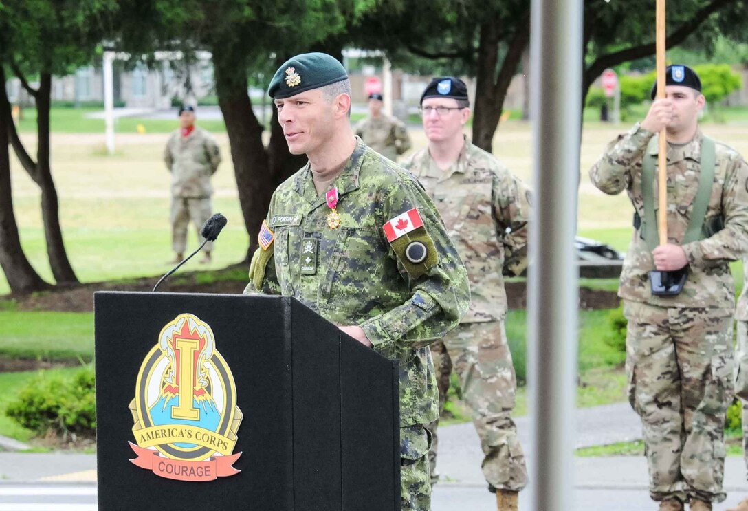 General speaks at outdoor lectern during ceremony.