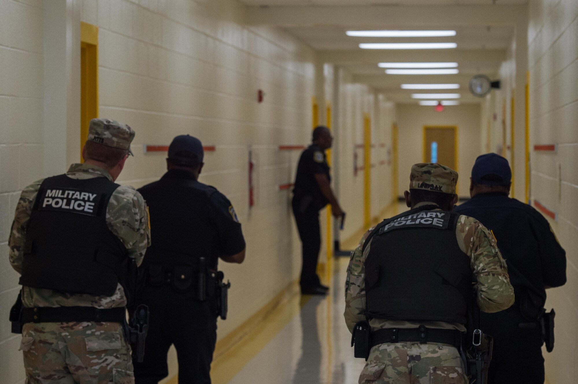 U.S. Army Soldiers and officers from the 733rd Security Forces Squadron clear rooms during a school violence exercise at Joint Base Langley-Eustis, Virginia, Aug. 23, 2018.