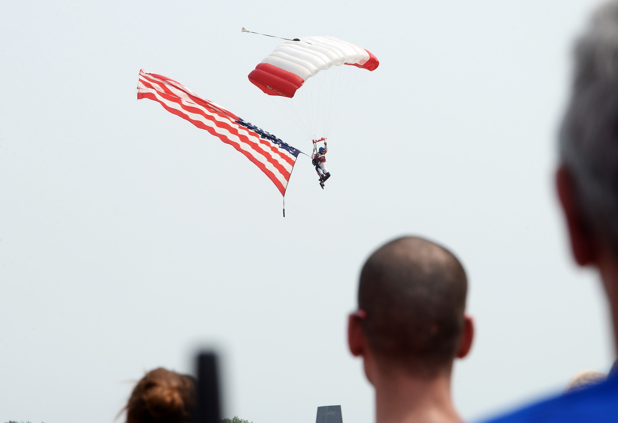 Michael Nugent, RE/MAX Skydiving Team, floats down to the ground while carrying the United States’ flag during the 2018 Defenders of Freedom Air and Space Show Aug. 11, at Offutt Air Force Base, Nebraska.