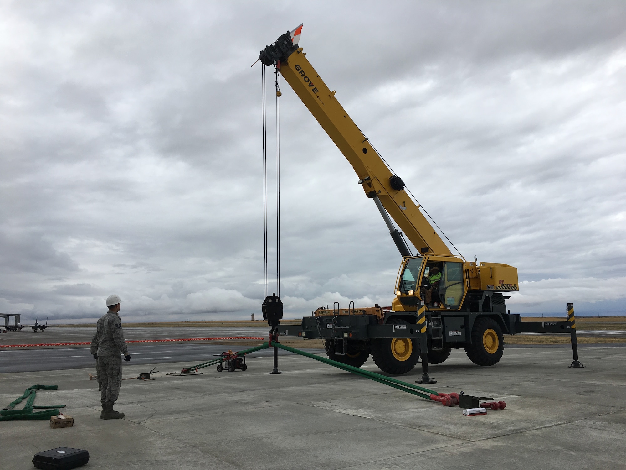 A member of the Airfield Pavement Evaluation Center conducts an anchor test on the airfield of Mountain Home Air Force Base, Idaho.