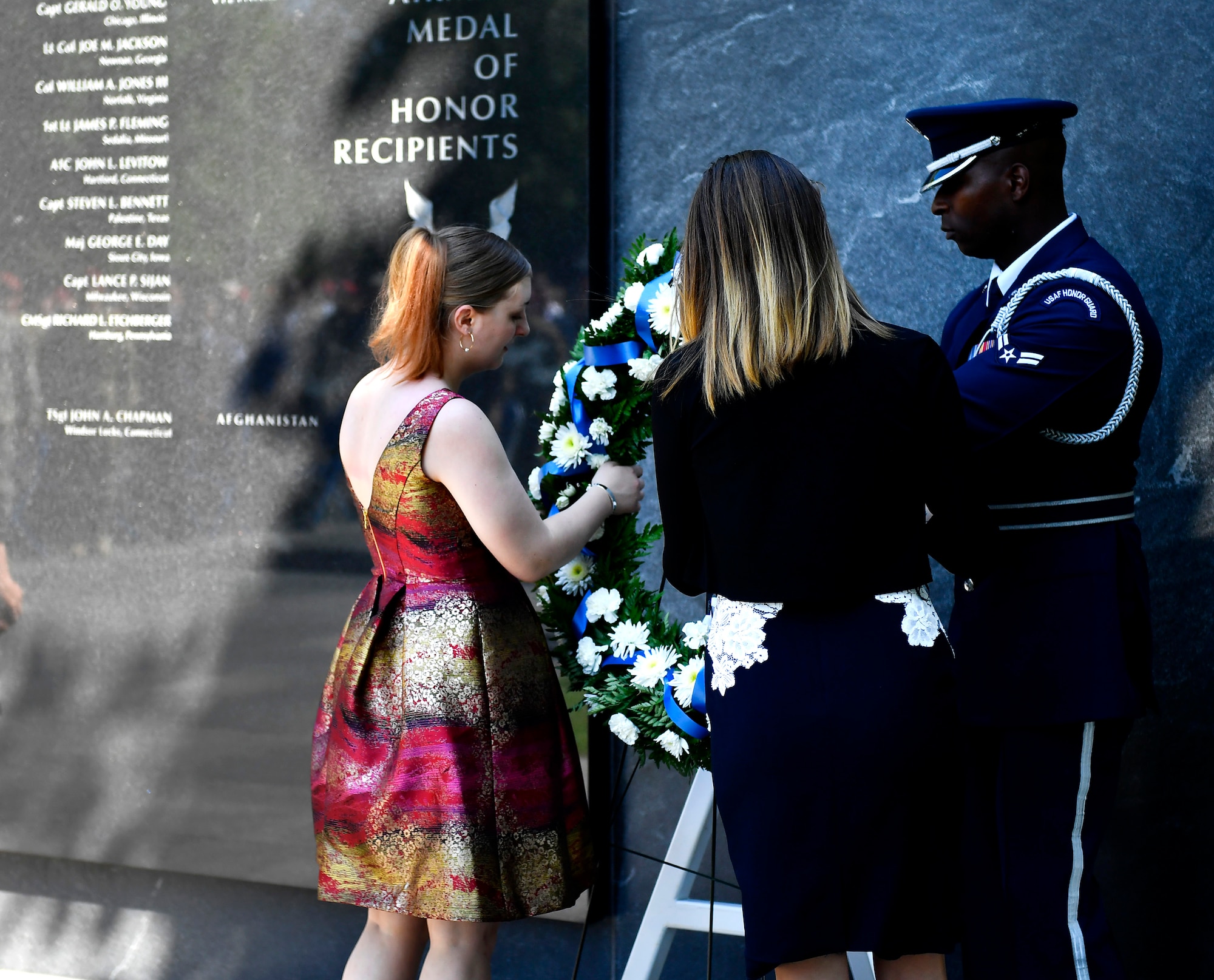 Brianna and Madison Chapman, daughters of Master Sgt. John Chapman, carry a wreath during the sergeant’s name unveiling ceremony at the Air Force Memorial in Arlington, Va., Aug. 24, 2018. Chapman was posthumously awarded the Medal of Honor for actions on Takur Ghar mountain in Afghanistan March 4, 2002. An elite special operations team was ambushed by the enemy and came under heavy fire from multiple directions. Chapman immediately charged an enemy bunker through thigh-deep snow and killed all enemy occupants. Courageously moving from cover to assault a second machine gun bunker, he was injured by enemy fire. Despite severe wounds, he fought relentlessly, sustaining a violent engagement with multiple enemy personnel before making the ultimate sacrifice. With his last actions he saved the lives of his teammates. (U.S. Air Force photo by Staff Sgt. Rusty Frank)