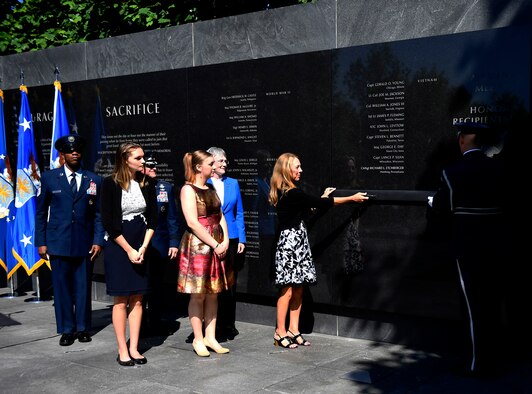 Valerie Nessel, widow of Master Sgt. John Chapman, along with daughters Brianna and Madison Chapman, Secretary of the Air Force Heather Wilson, Air Force Chief of Staff Gen. David L. Goldfein and Chief Master Sgt. of the Air Force Kaleth O. Wright unveil the name of Master Sgt. John Chapman during a ceremony at the Air Force Memorial in Arlington, Va., Aug. 24, 2018. Chapman was posthumously awarded the Medal of Honor for actions on Takur Ghar Mountain in Afghanistan March 4, 2002. An elite special operations team was ambushed by the enemy and came under heavy fire from multiple directions. Chapman immediately charged an enemy bunker through thigh-deep snow and killed all enemy occupants. Courageously moving from cover to assault a second machine gun bunker, he was injured by enemy fire. Despite severe wounds, he fought relentlessly, sustaining a violent engagement with multiple enemy personnel before making the ultimate sacrifice. With his last actions he saved the lives of his teammates. (U.S. Air Force photo by Staff Sgt. Rusty Frank)