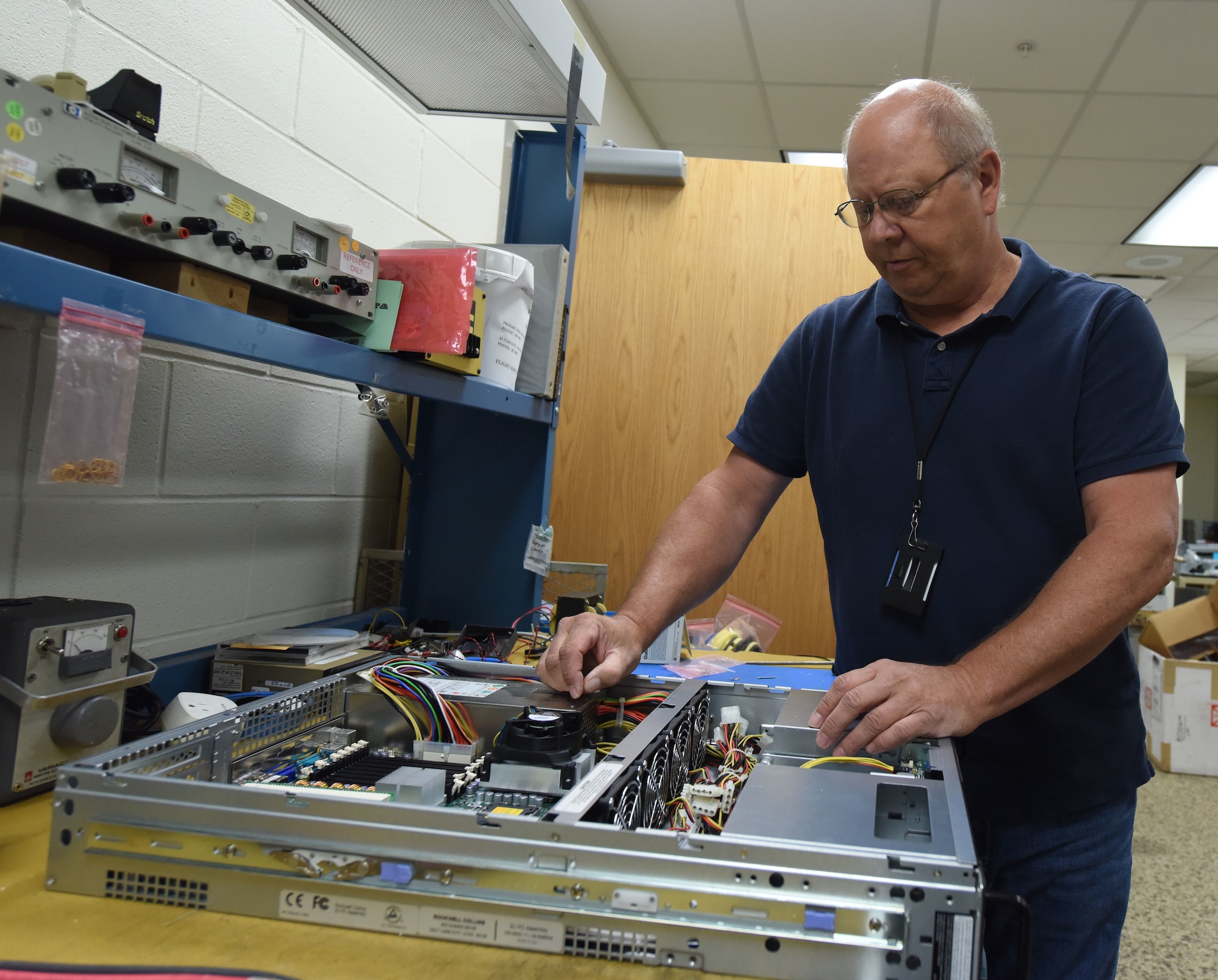 Randy Mack, a B-1 simulator maintenance technician, works on a piece of computer equipment at Ellsworth Air Force Base, S.D., Aug. 21, 2018. The B-1 simulator is a state-of-the-art facility, which is powered by multiple computers so it can display images and allow aircrew members to complete realistic training scenarios. (U.S. Air Force photo by Airman 1st Class Thomas Karol)