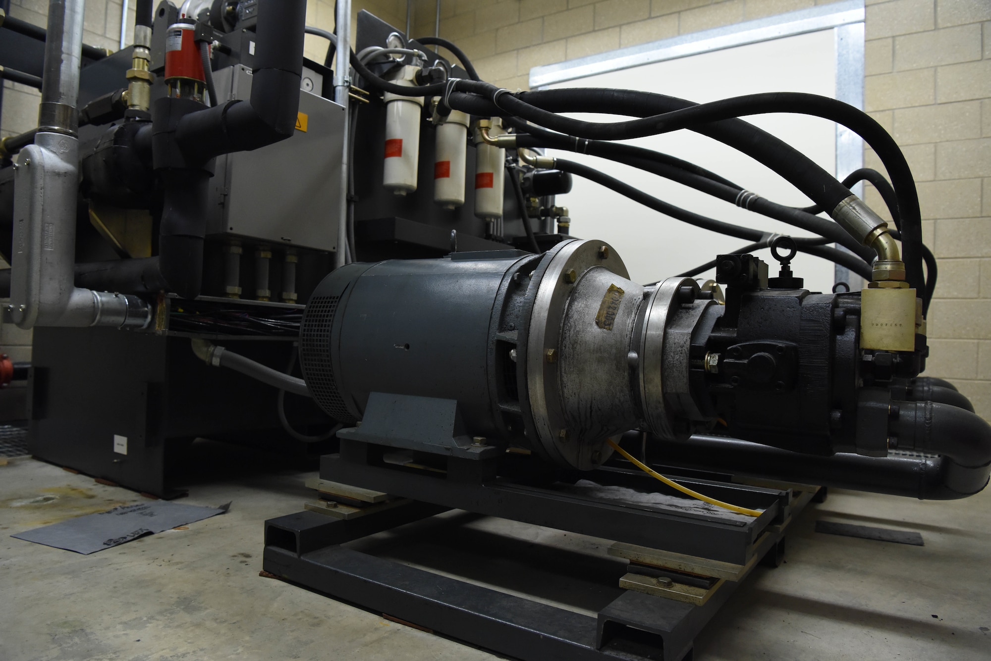 Hydraulic pumps power a weapon systems trainer so it can move during aircrew training exercises at Ellsworth Air Force Base, S.D., Aug. 21, 2018. The WSTs sit on hydraulic legs that allow them to turn forwards and backwards during training to make it as realistic as possible so aircrew members can receive better training. (U.S. Air Force photo by Airman 1st Class Thomas Karol)