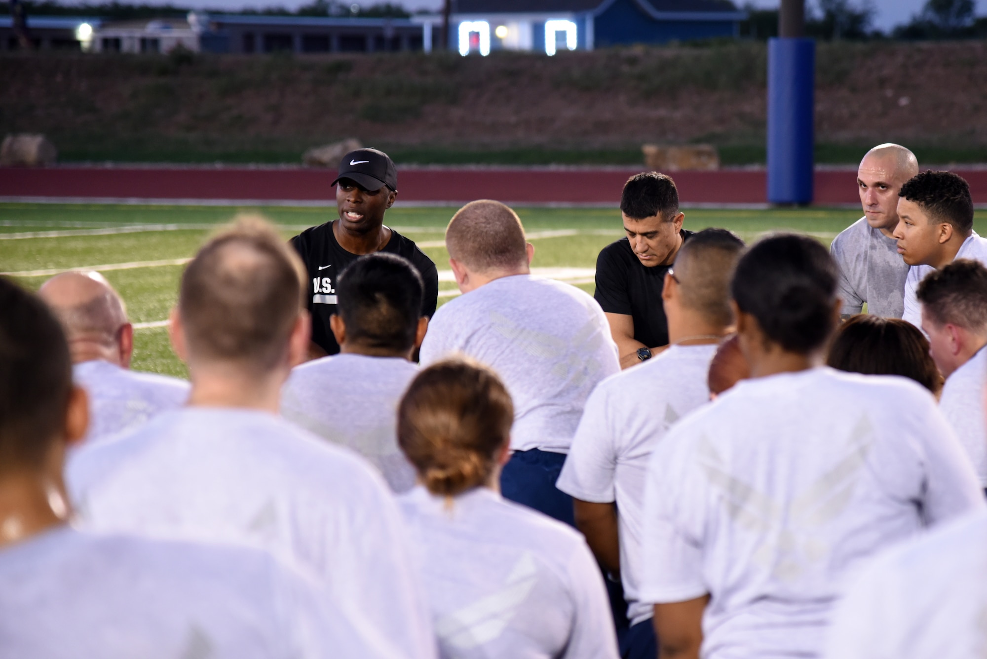 U.S. Air Force Chief Master Sgt. Lavor Kirkpatrick, 17th Training Wing command chief, speaks to Airmen after a Master Sgt. John Chapman inspire CrossFit workout at the Mathis football field on Goodfellow Air Force Base, Texas, Aug. 24, 2018. Kirkpatrick hosted the workout to honor Chapman who is the latest service member to receive the Medal of Honor. (U.S. Air Force photo by Staff Sgt. Joshua Edwards/Released)