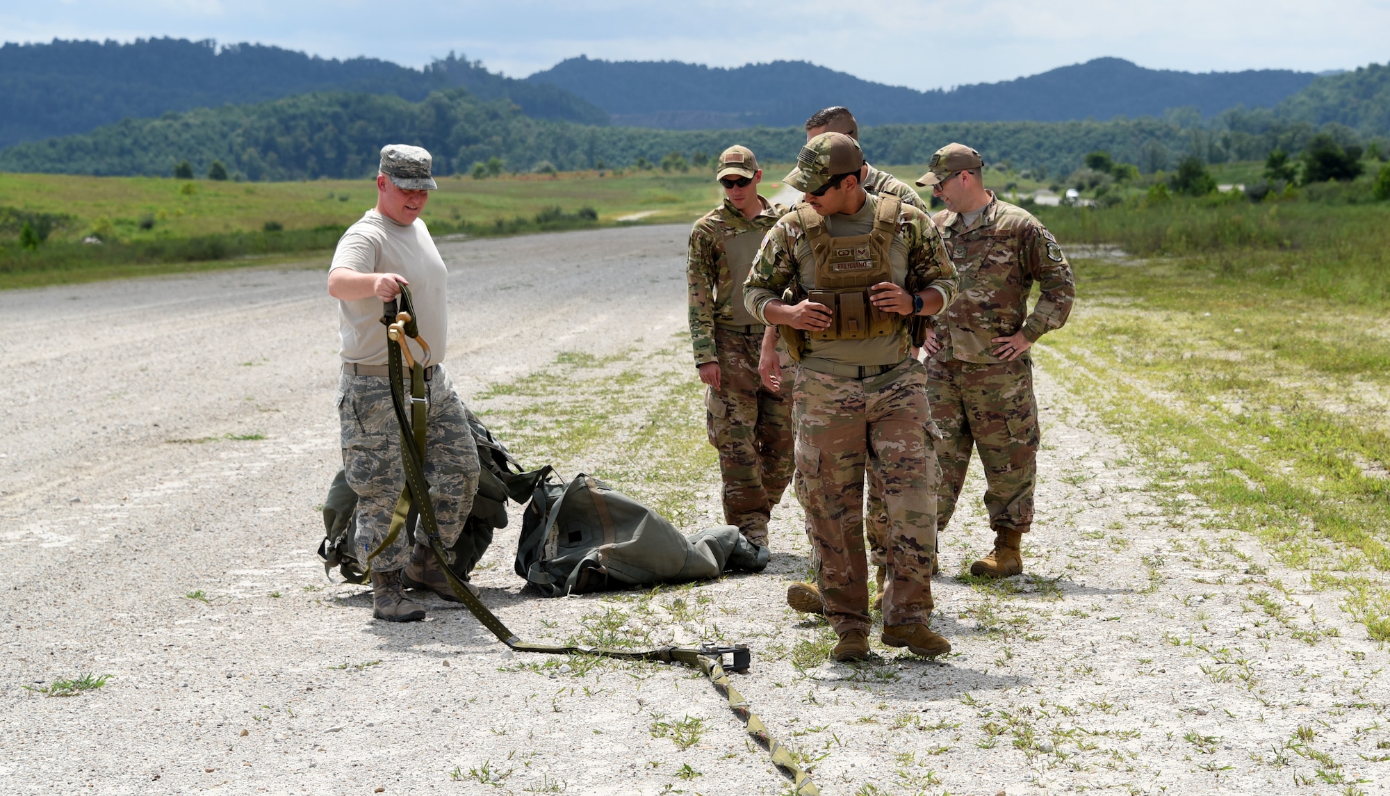 Airmen with the 621st Contingency Response Group work alongside the 130th Air National Guard to retrieve air drops at Camp Branch in Logan County, W.Va., Aug. 21, 2018. The 621st CRG spent four days training with and working with the 130th ANG at Camp Branch practicing semi-prepared runway operations. (U.S. Air Force photo by Tech. Sgt. Jamie Powell)