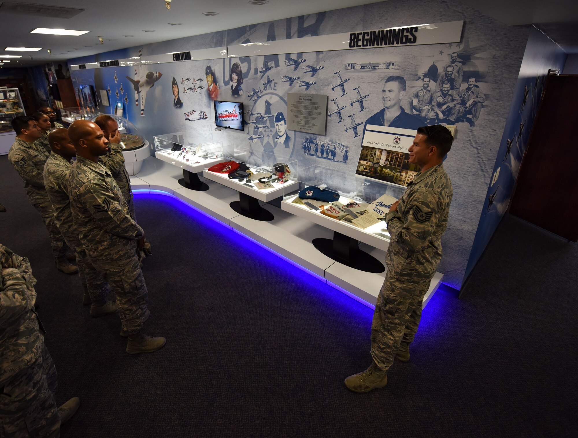 Tech. Sgt. Daniel Wolfrum, Thunderbirds plans and scheduling NCO in charge, conducts a tour of the Thunderbird museum at Nellis Air Force Base, Nevada, Aug. 16, 2018. The museum displays Thunderbirds heritage, memorabilia and current team members. (U.S. Air Force photo by Airman 1st Class Andrew D. Sarver)