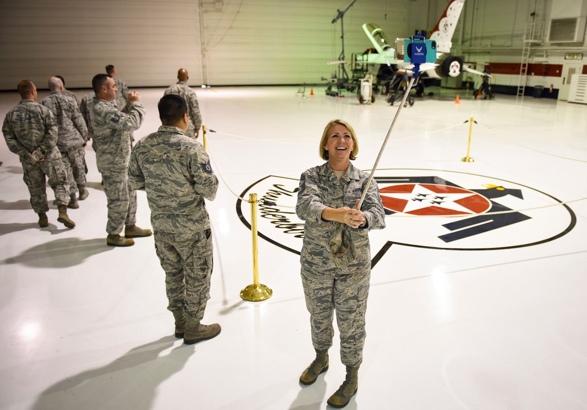 Chief Master Sgt. Kathleen McCool, 53rd Wing command chief at Eglin Air Force Base, Florida, takes a picture in the Thunderbirds hangar during a tour with the Warrior Stripe program at Nellis Air Force Base, Nevada, Aug. 18, 2018. The two-week course brought together 40 U.S. Air Force Warfare Center NCOs to provide an avenue for them to develop as military and professional leaders. (U.S. Air Force photo by Airman 1st Class Andrew D. Sarver)