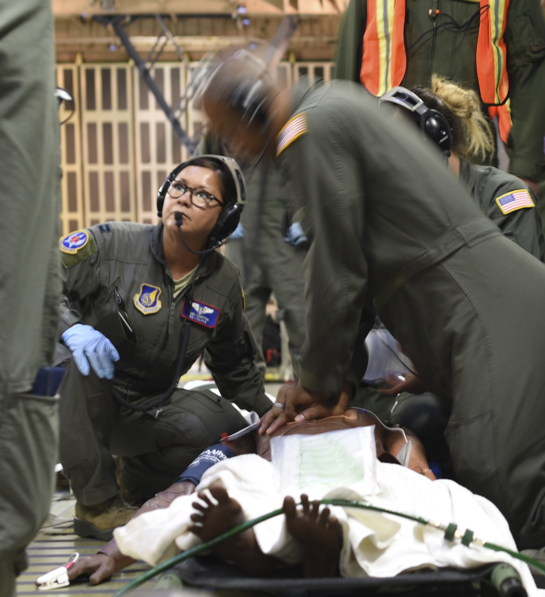 U.S. Air Force Staff Sgt. Jamal Wardlaw, 59th Medical Wing cardio pulmonary technician, center, performs cardio pulmonary resuscitation on a simulated patient during Exercise Ultimate Caduceus 2018 at Travis Air Force Base, California, Aug. 23, 2018. Ultimate Caduceus 2018 is an annual patient movement exercise designed to test the ability of U.S. Transportation Command to provide medical evacuation. (U.S. Air Force photo by Staff Sgt. Amber Carter)