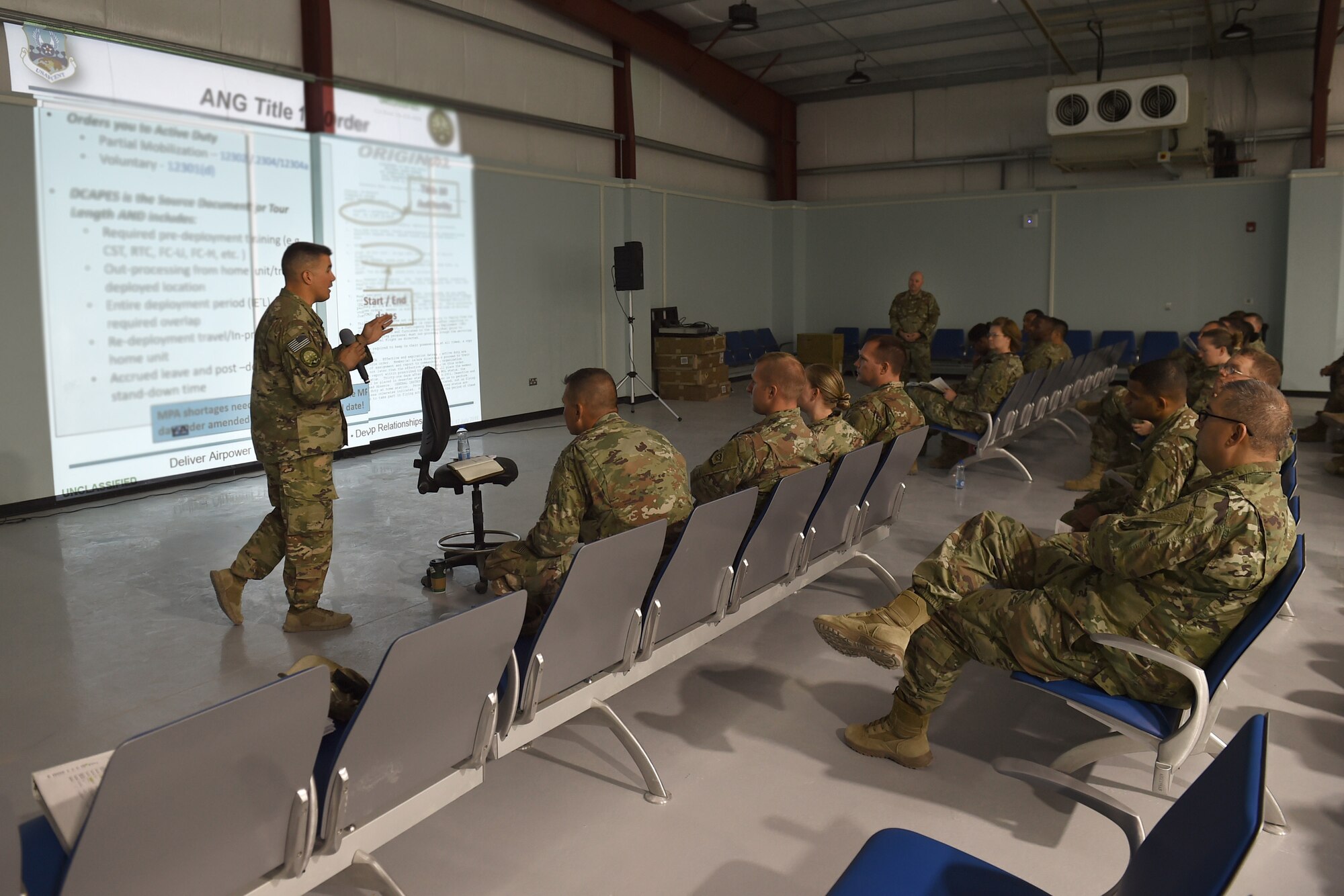 Two Airmen give a power point briefing