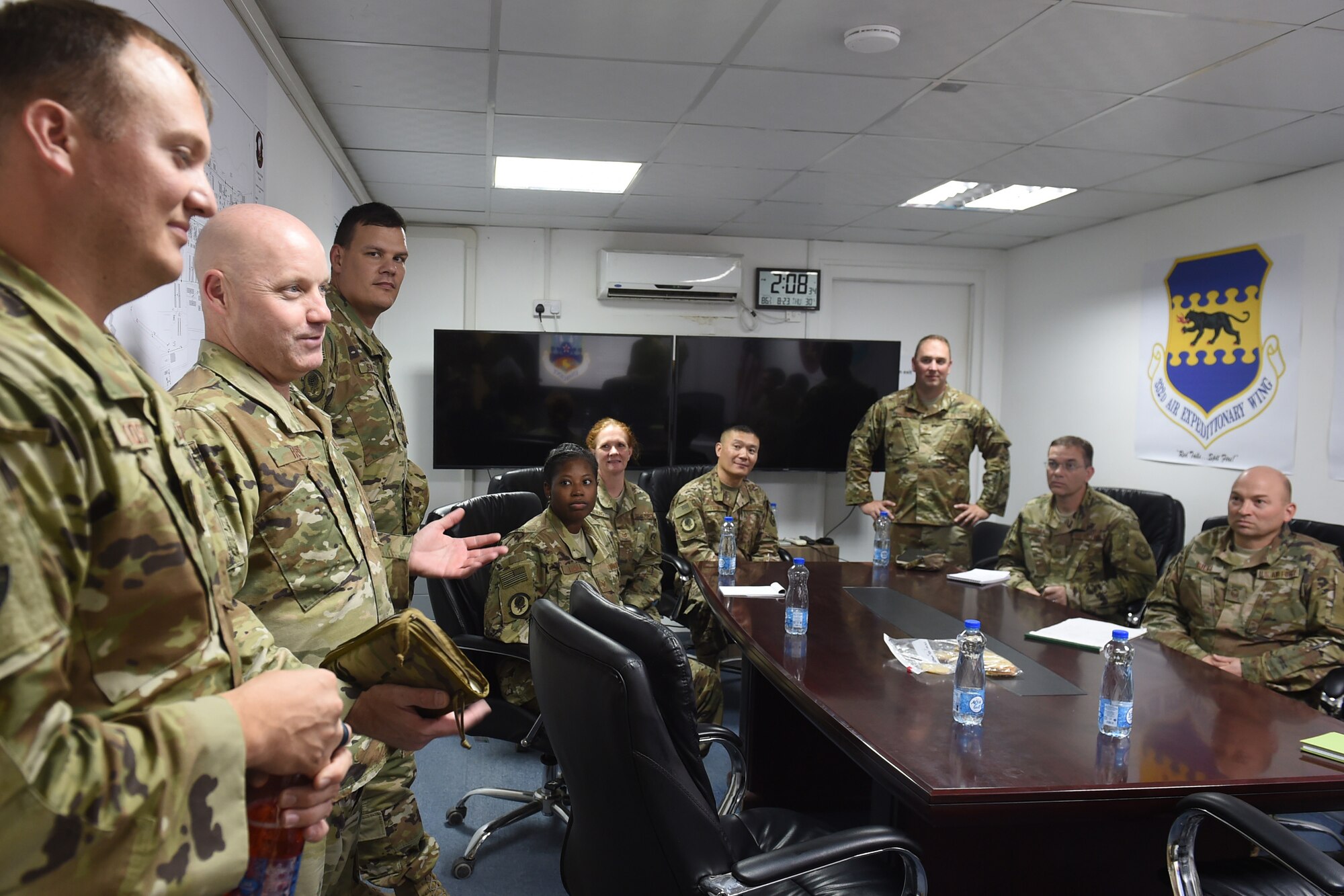 Airmen sit at a conference table
