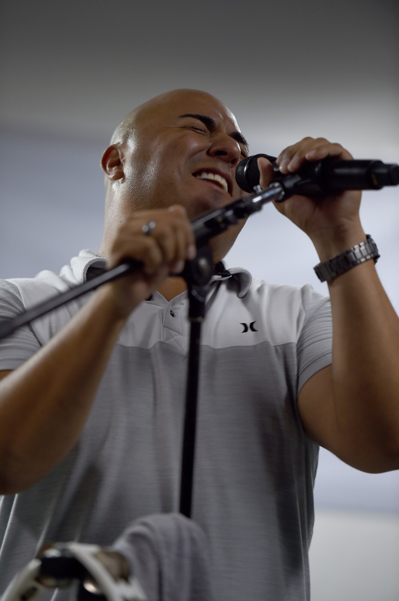 Airman sings on a small stage