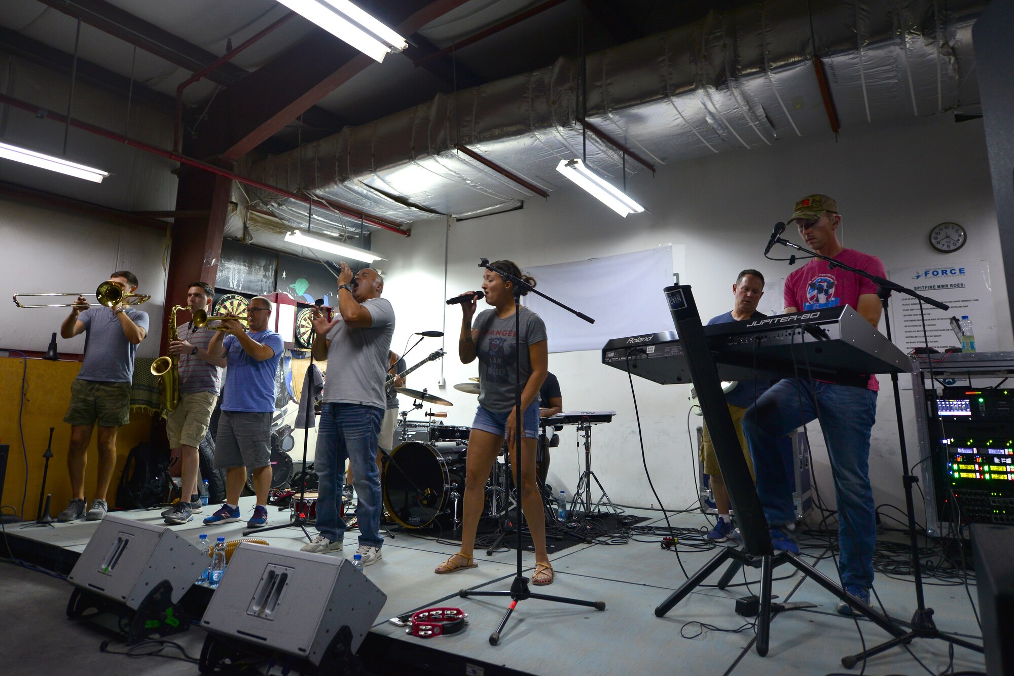 AFCENT Band sings on a small stage