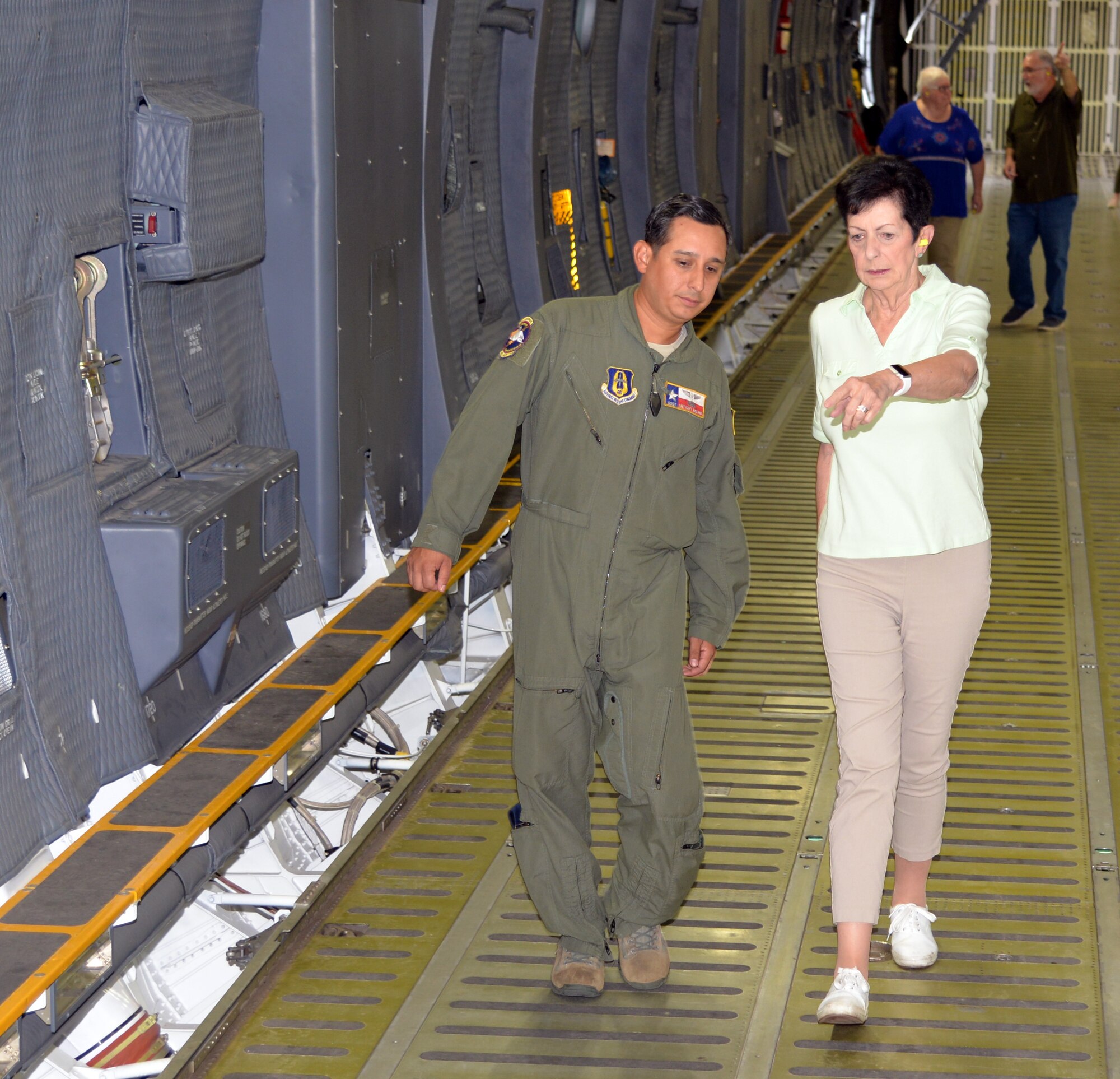 Retired U.S. Air Force Col. Regina Aune talks to Staff Sgt. Anthony B. Molina, 68th Airlift Squadron flight engineer, about how her team loaded children on the aircraft during Operation Babylift. Aune and guest toured a C-5M Super Galaxy Aug. 20, 2018 at Joint Base San Antonio-Lackland, Texas. (U.S. Air Force photo by Master Sgt. Kristian Carter)