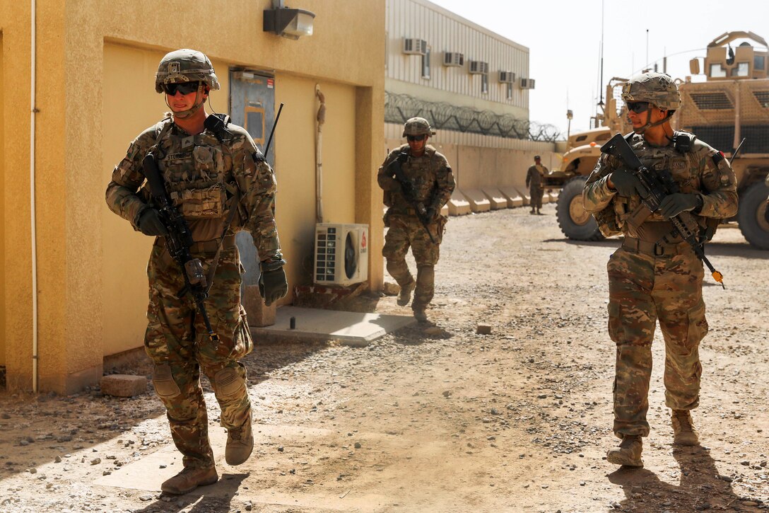 Soldiers conduct a patrol through a simulated village.