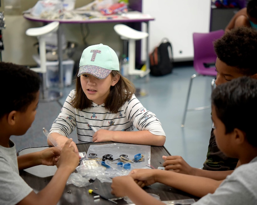 Trinity Raymond, a 12-year-old students at the Center of Innovation works with peers to build a solar panel toy car at the Youth Center on Joint Base Andrews, Md., July 6, 2018. The COI was transformed in 2015 after receiving funding from the Boys and Girls Club of America and Raytheon to accommodate lessons in science, technology, engineering and math.