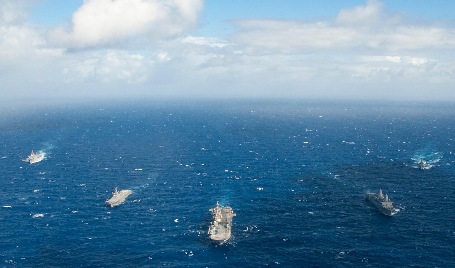 The amphibious assault ship USS Wasp (LHD 1), along with the transport dock ship USS Green Bay (LPD 20), dock landing ship USS Ashland (LSD 48), and Arleigh Burke class guided missile destroyer USS Shoup (DDG 86), sail alongside the Japan Maritime Self Defense Force (JMSDF) amphibious transport dock ship JS Osumi (LST 4001) during a Passing Exercise (PASSEX) in the Philippine Sea Aug. 26, 2018. PASSEX enabled the Wasp Amphibious Ready Group and the JMSDF a chance to practice communications and maneuvering procedures. The Wasp ARG is currently operating in the region to enhance interoperability with partners and serve as a ready-response force for any type of contingency.