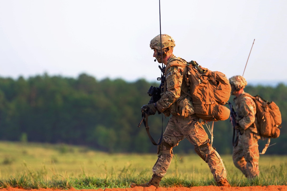 Soldiers move to an assembly area after conducting a static-line airborne operation.